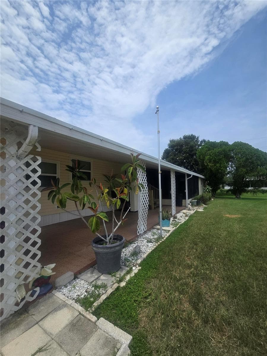Exterior of carport with paver golf cart pad - 4645 BURNEY DR, HOLIDAY