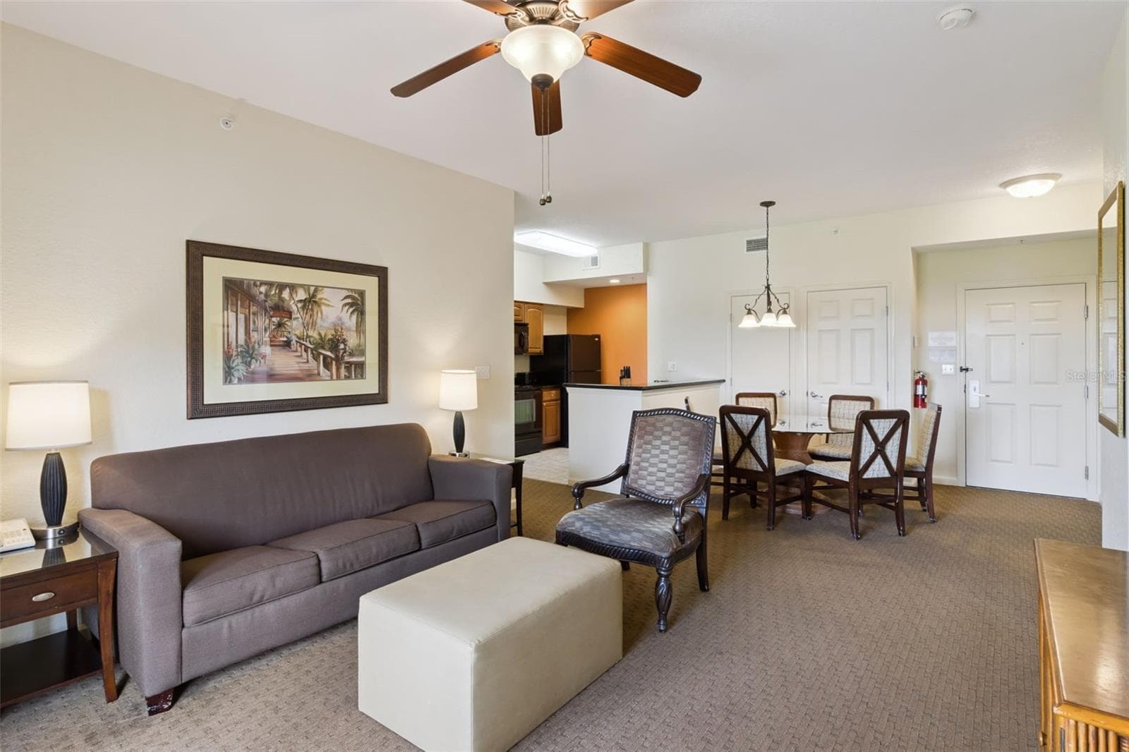 Open-Concept Living Space | Living room flows seamlessly into the dining area and kitchen. - 8101 RESORT VILLAGE DR #31110, ORLANDO