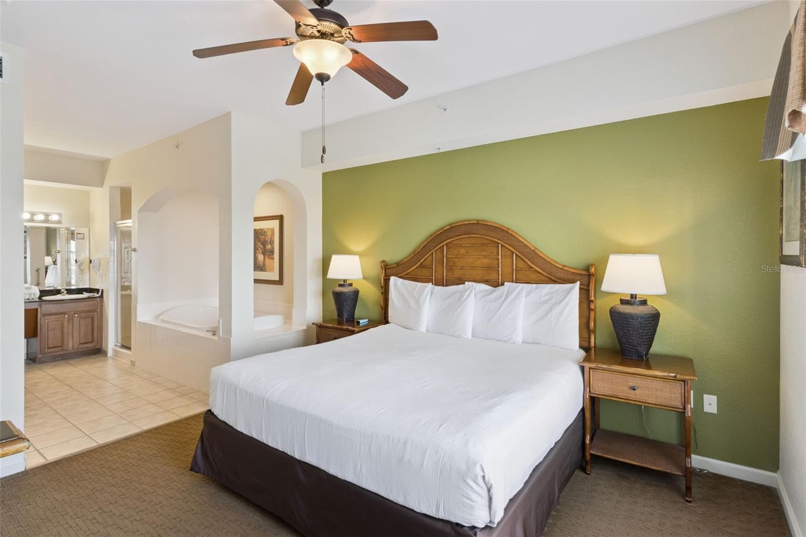 Primary Bedroom | The bedroom offers direct access to the adjoining bath area and an open layout. - 8101 RESORT VILLAGE DR #31110, ORLANDO