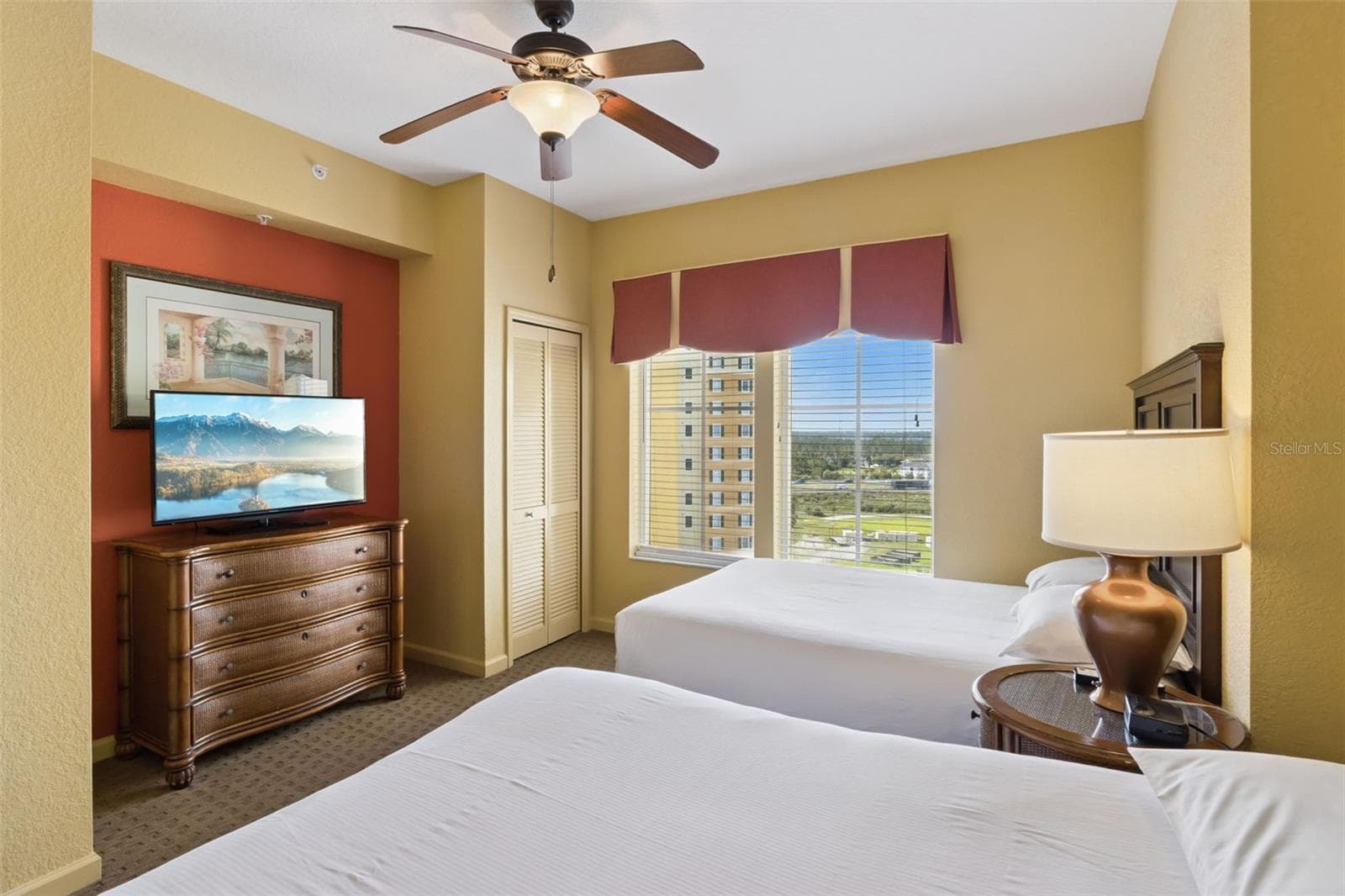 Guest Bedroom | This bedroom includes two beds, a ceiling fan, and windows overlooking the resort. - 8101 RESORT VILLAGE DR #31110, ORLANDO