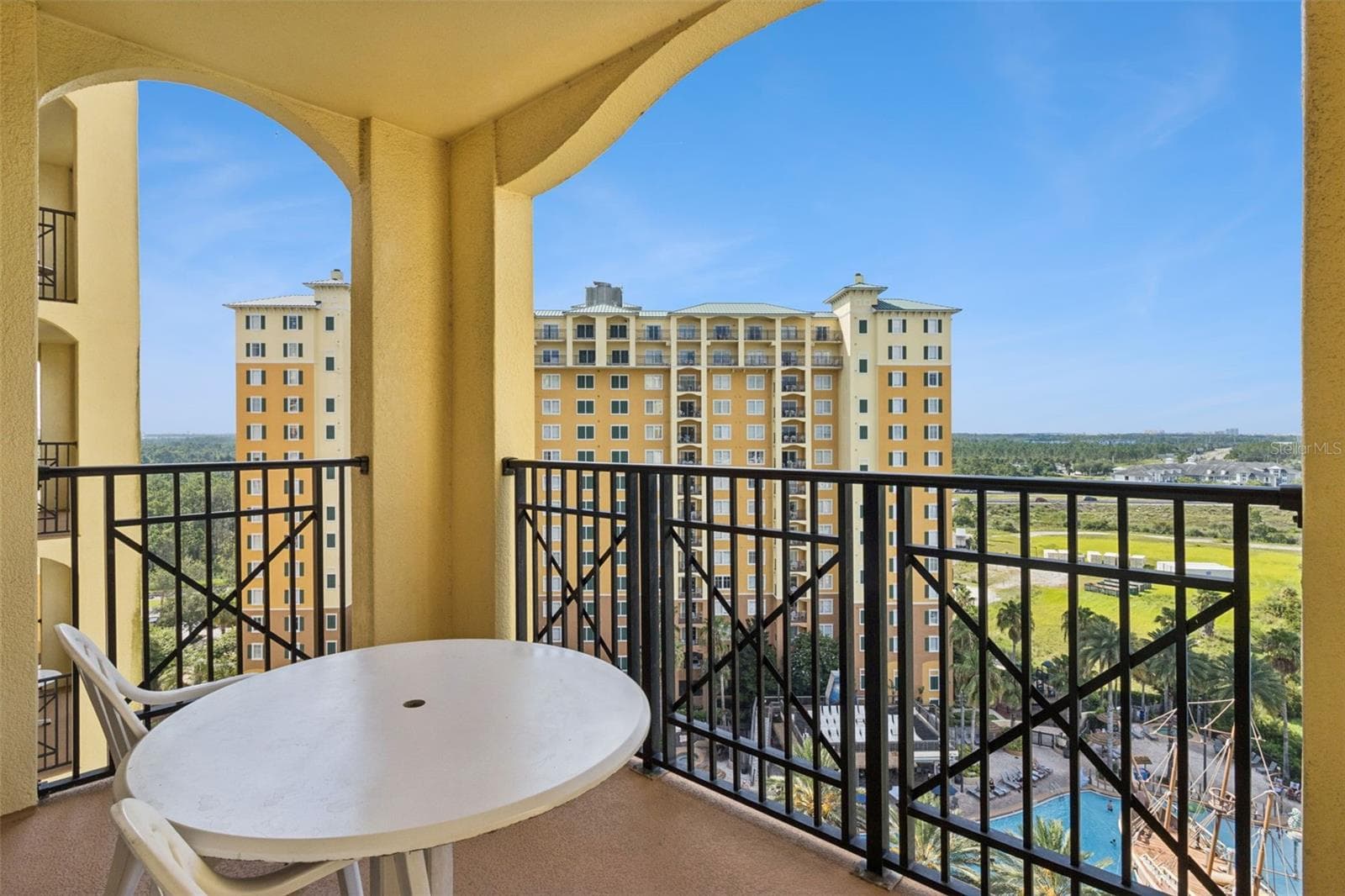 Covered Balcony | The private balcony provides a shaded outdoor setting for morning coffee or relaxing after a day at the parks. - 8101 RESORT VILLAGE DR #31110, ORLANDO