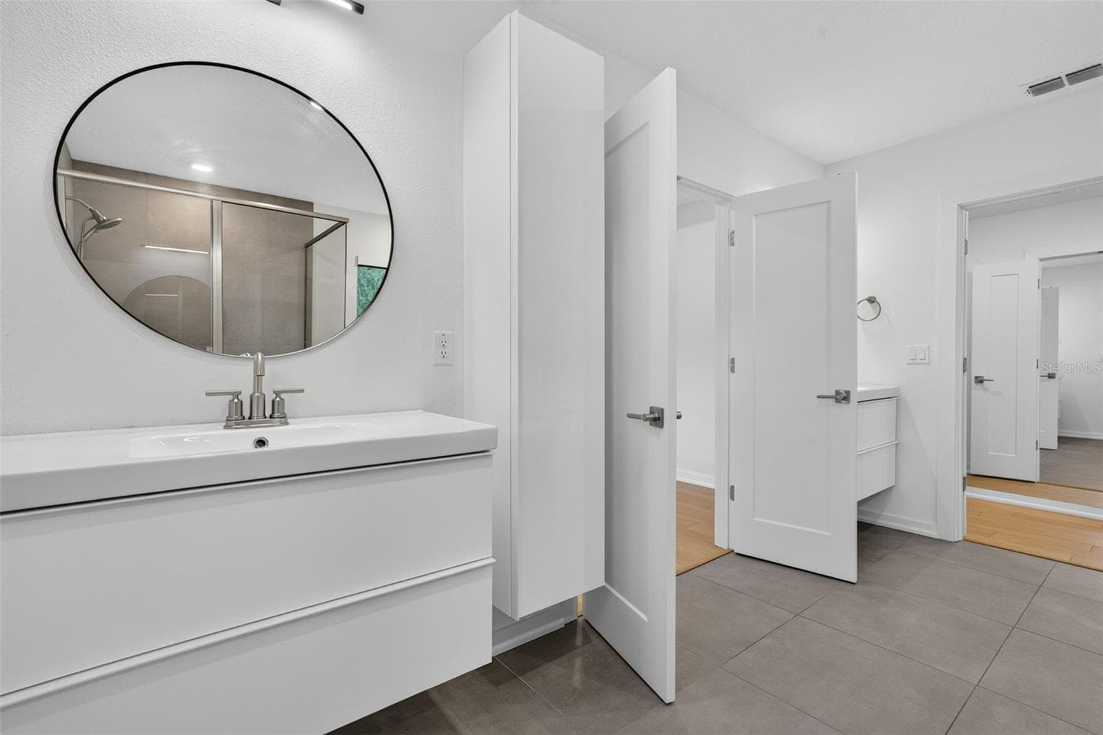 Master Bath-floating dual sinks-individual spaces- Master closet with doors and built in shelves. - 5818 1/2 S 6TH ST, TAMPA