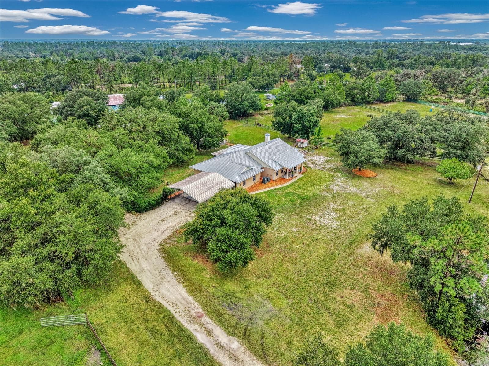 The carport and parking space for the home - 4610 403RD ST E, MYAKKA CITY