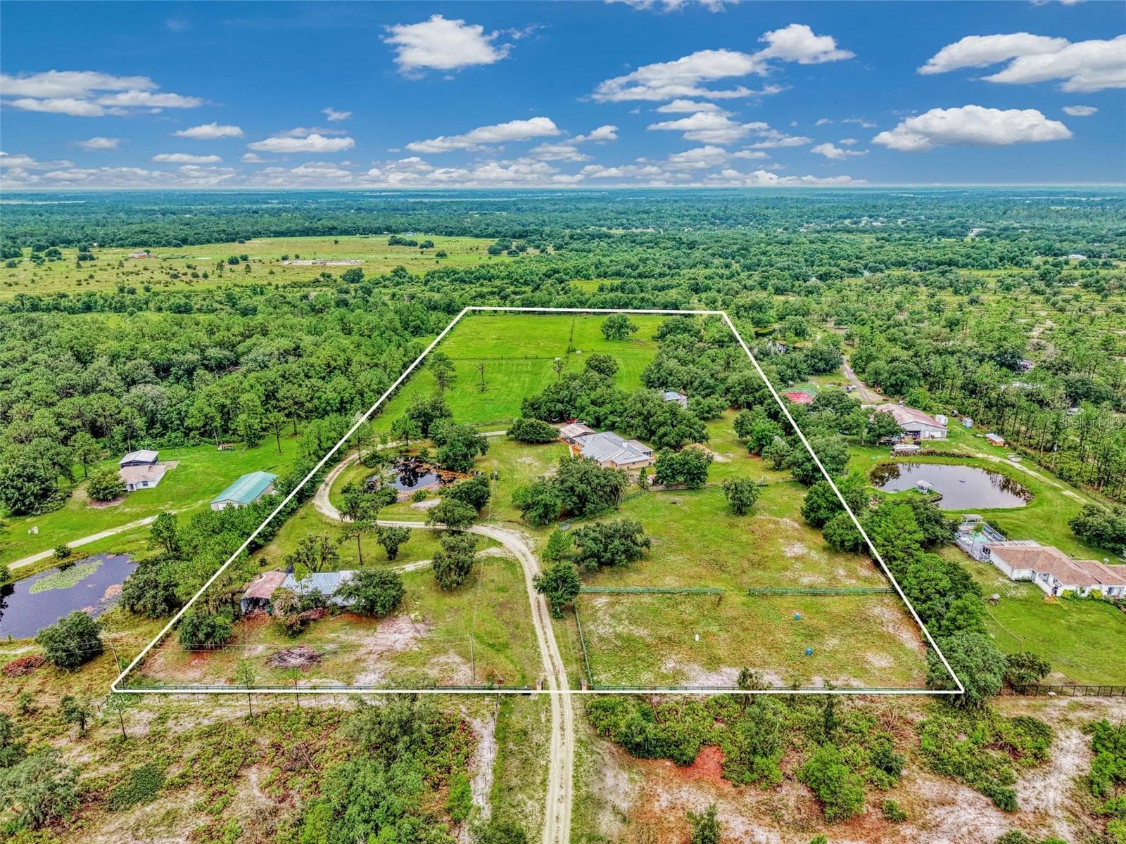 Turn onto 403rd st E and follow the long gravel driveway to the front gate - 4610 403RD ST E, MYAKKA CITY
