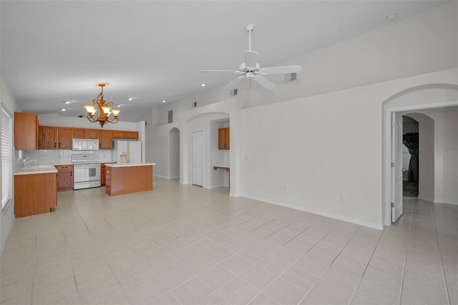 VIEW OF KITCHEN FROM FAMILY ROOM SLIDERS. - 12021 FERN TERRACE CT, TRINITY