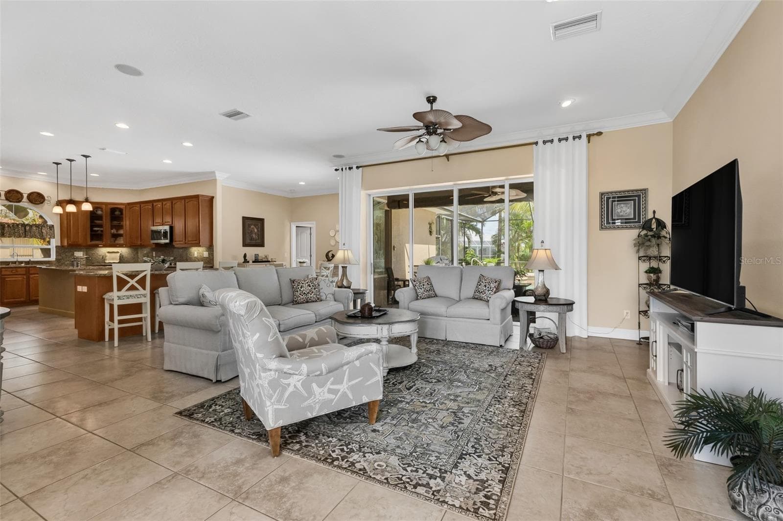 Tile flooring, 10ft ceilings and pocketing 4 panel sliding doors that open to the Pool/Lanai - 24228 PEPPERCORN RD, PUNTA GORDA