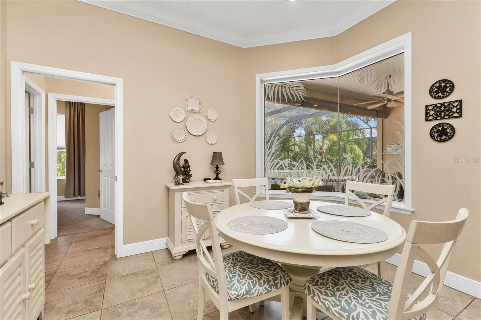 Dining with elegant, mitered window overlooking the pool area - 24228 PEPPERCORN RD, PUNTA GORDA