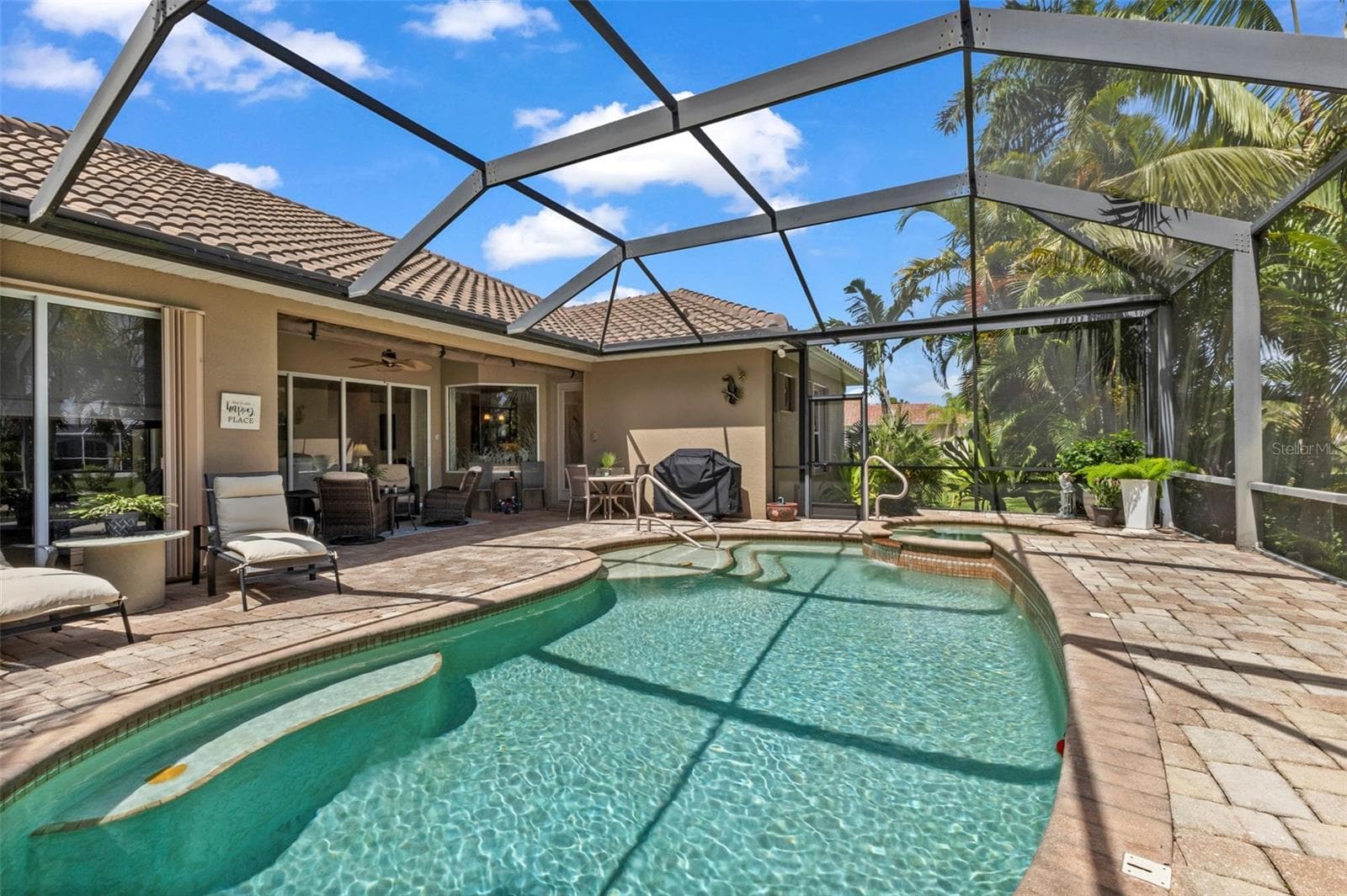 Impressive paver deck goes all the way to the under truss seating area - 24228 PEPPERCORN RD, PUNTA GORDA