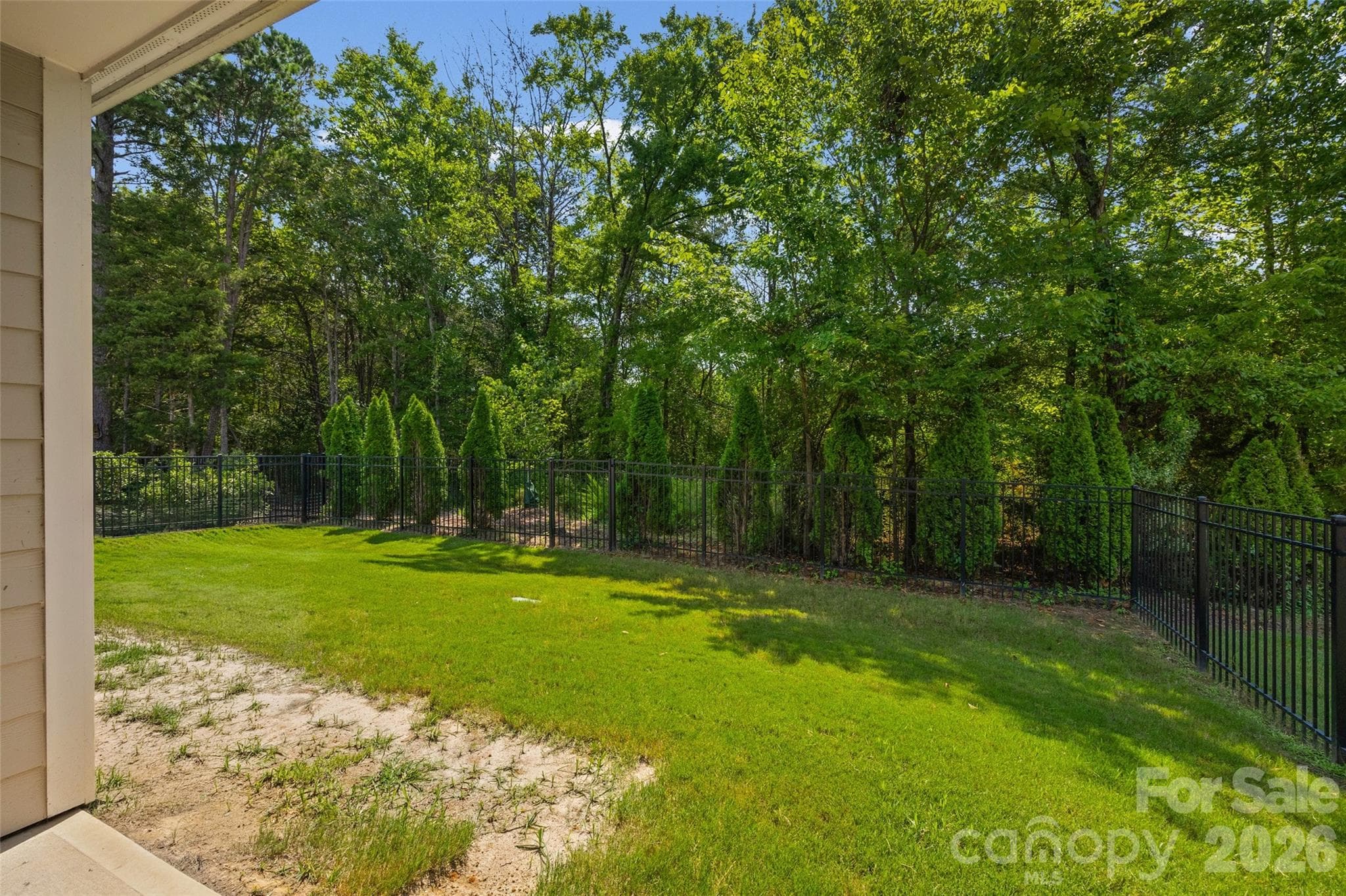 Fully fenced backyard offers a safe space for kids and pets to play while you relax on the covered porch and keep an eye on the fun. - 596 Rustlewood Way, Rock Hill