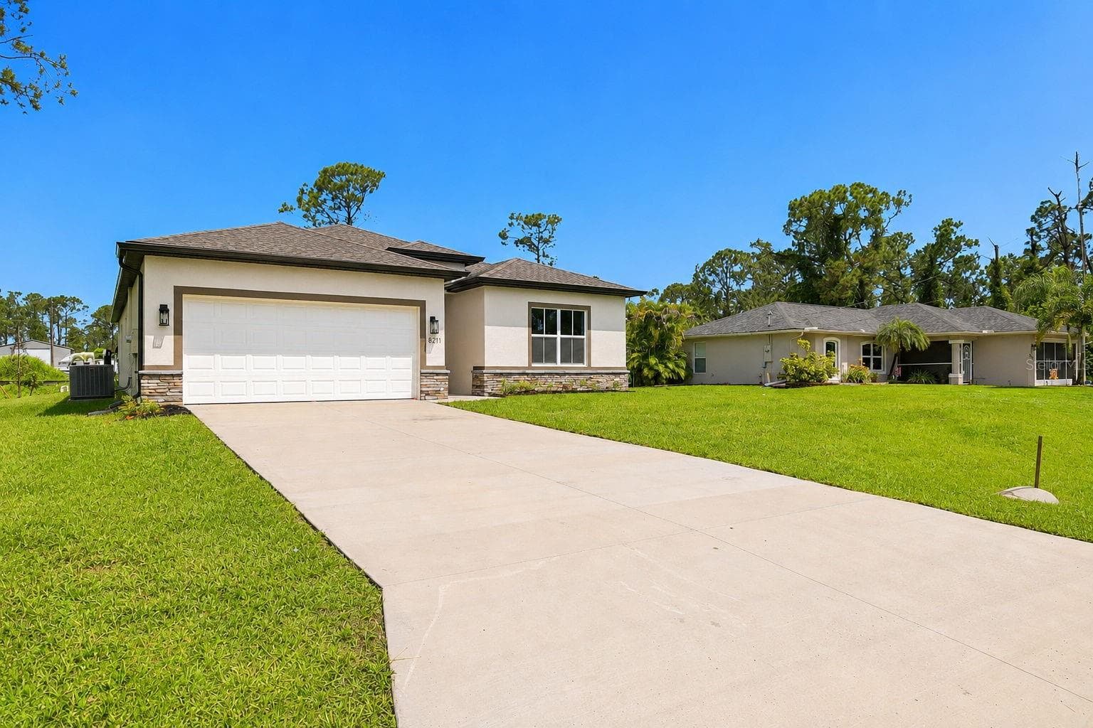 Long driveway and 2-car garage offers plenty of parking. - 8211 ELKENBERRY AVE, NORTH PORT