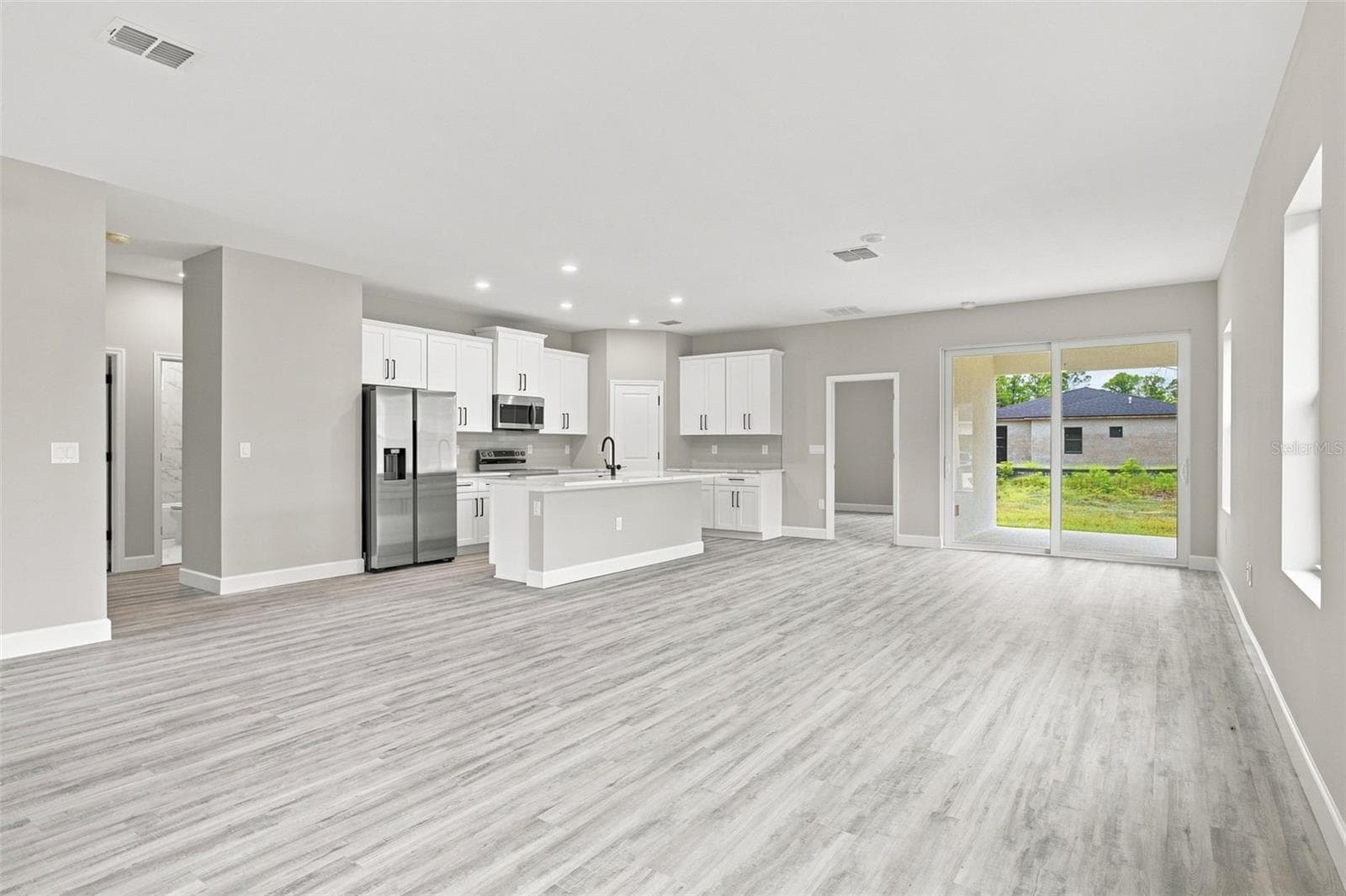 Easy access to the outdoors from the kitchen and great room. - 8211 ELKENBERRY AVE, NORTH PORT