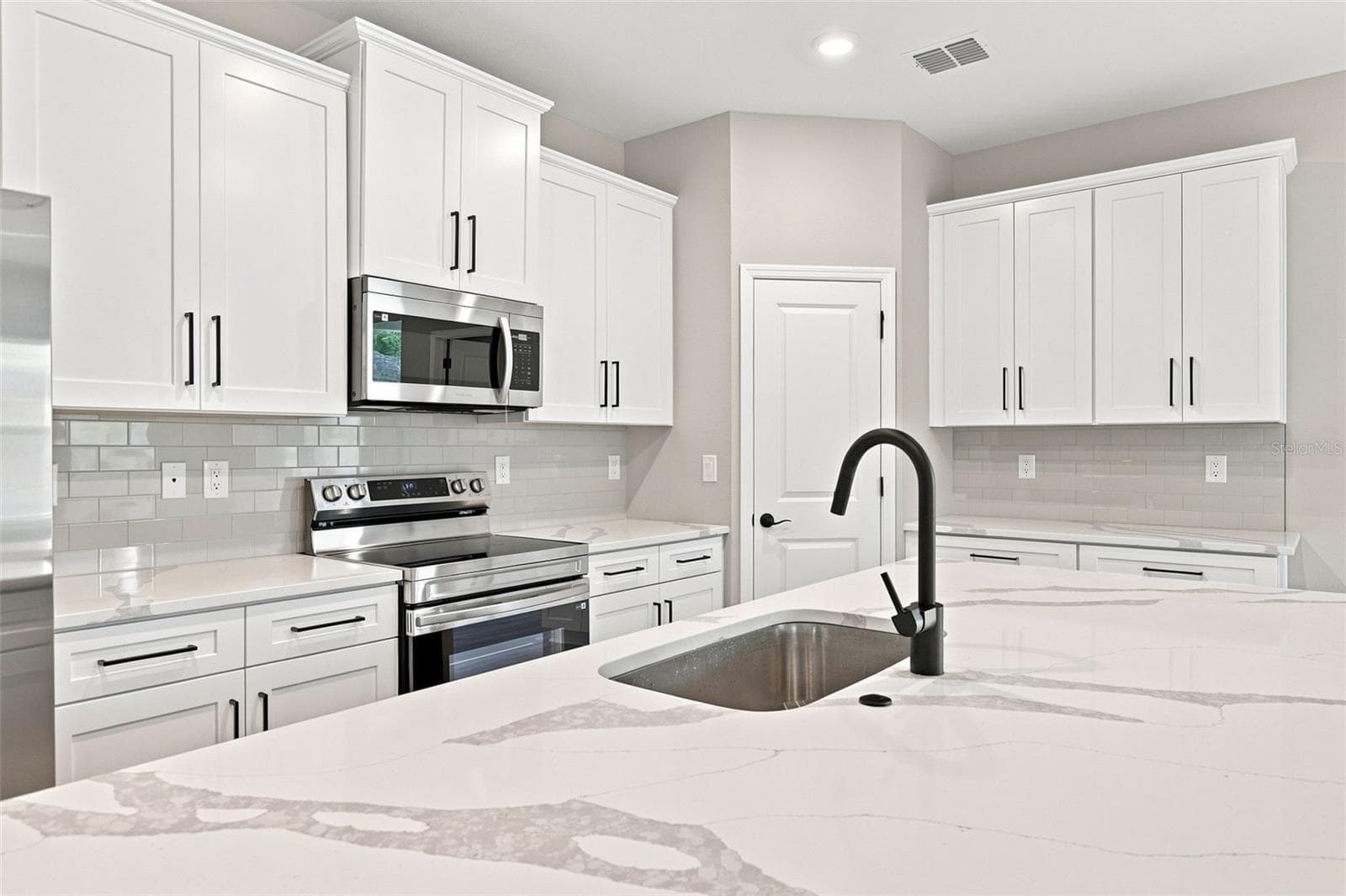 Samsung stainless appliances and plentiful storage. - 8211 ELKENBERRY AVE, NORTH PORT