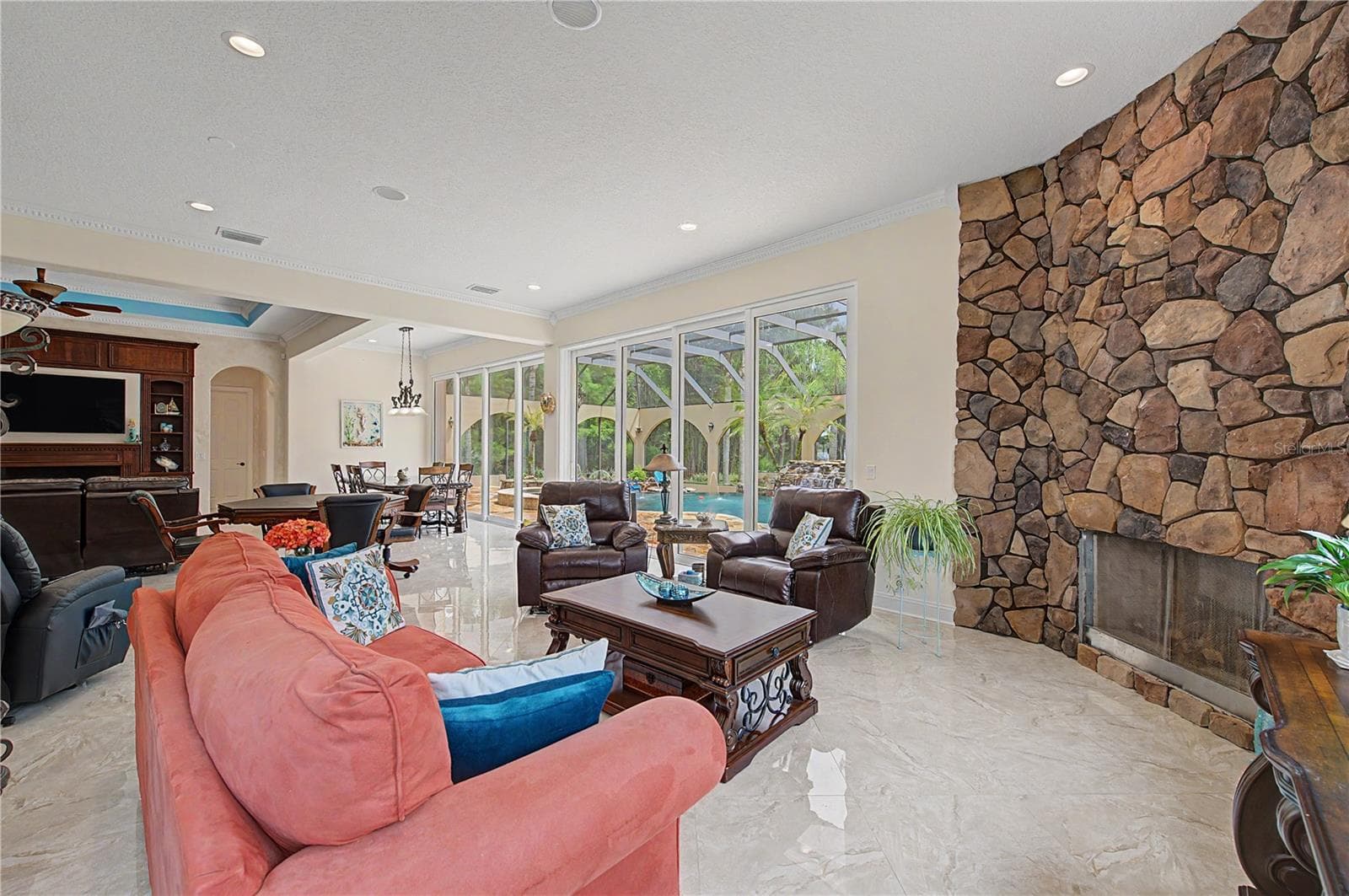 Expansive Family Room with view of Beautiful Pool Oasis, Backyard and Lake - 21246 QUIET HAVEN CT, LAND O LAKES