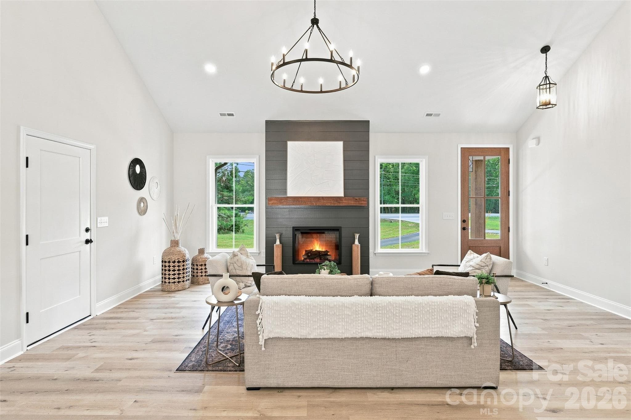 living room w/ vaulted ceiling and electric shiplap fireplace - 390 NC 200 Highway S, Stanfield