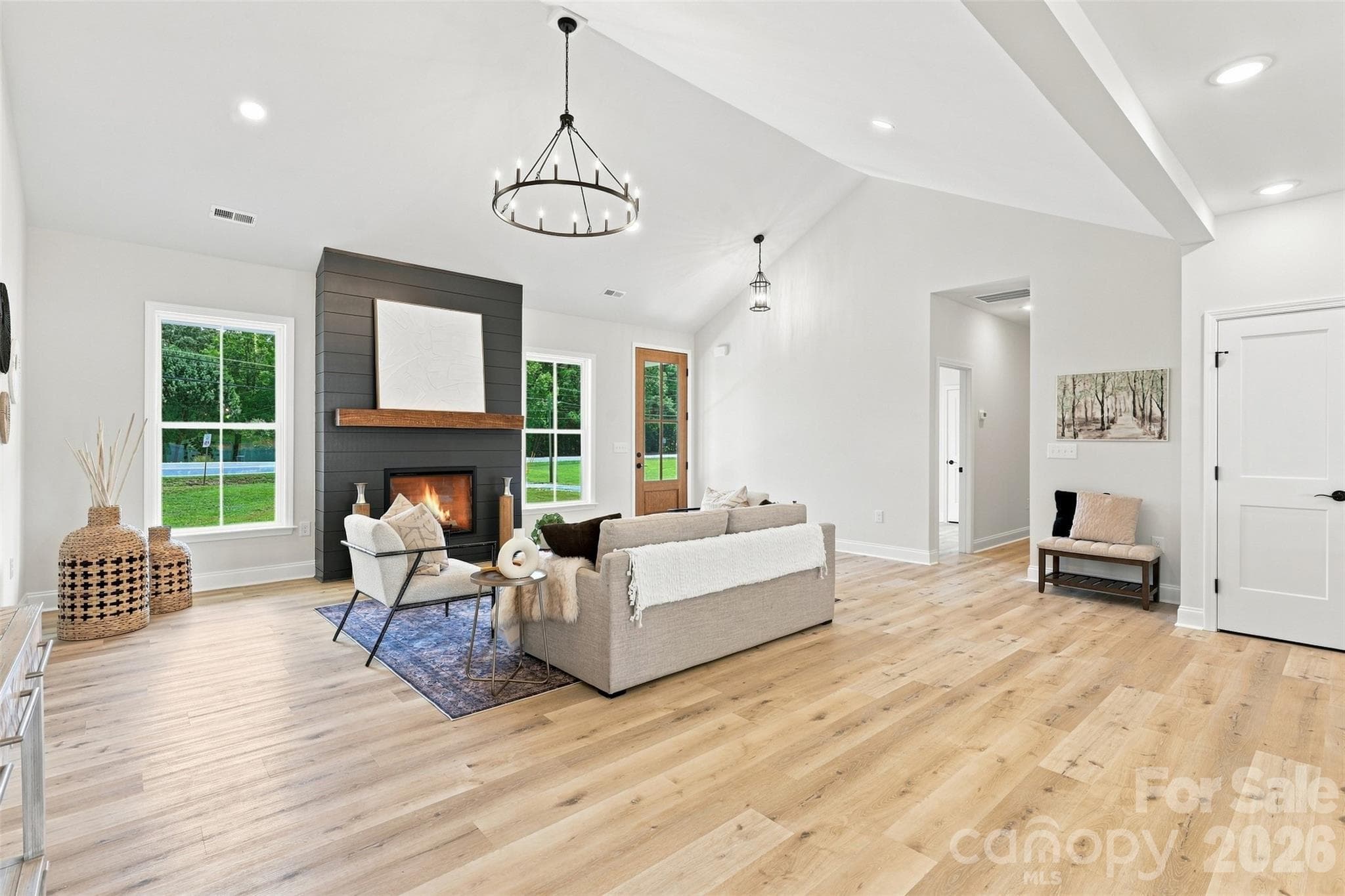 living room w/ vaulted ceiling and electric shiplap fireplace - 390 NC 200 Highway S, Stanfield