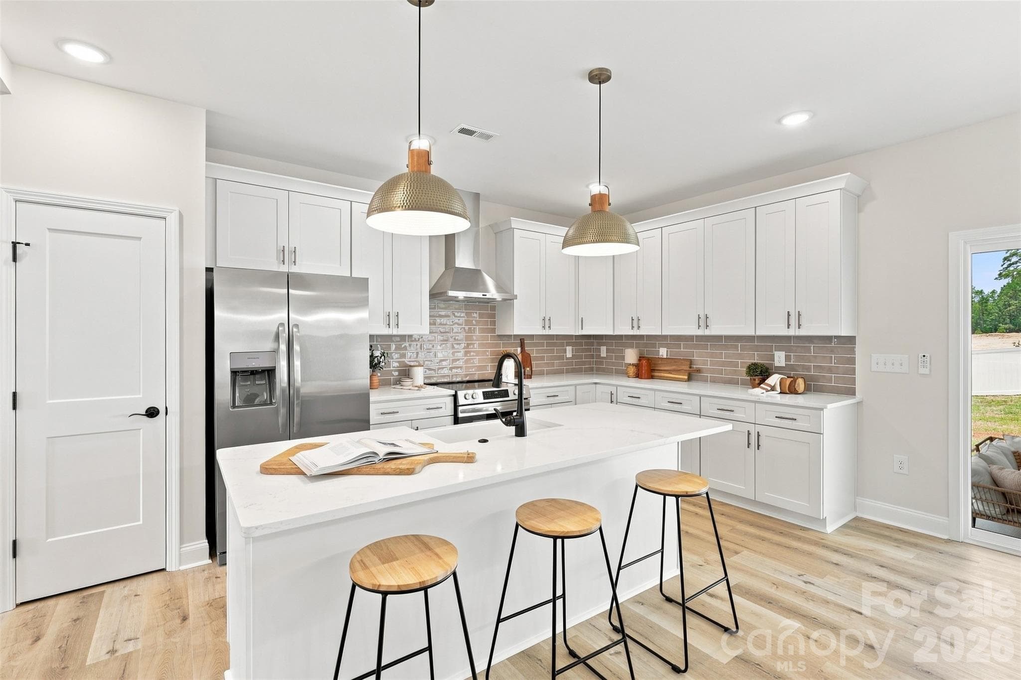 kitchen w/ thoughtfully updated cabinets & countertops, porcelain farmhouse sink, stainless steel hood vent - 390 NC 200 Highway S, Stanfield