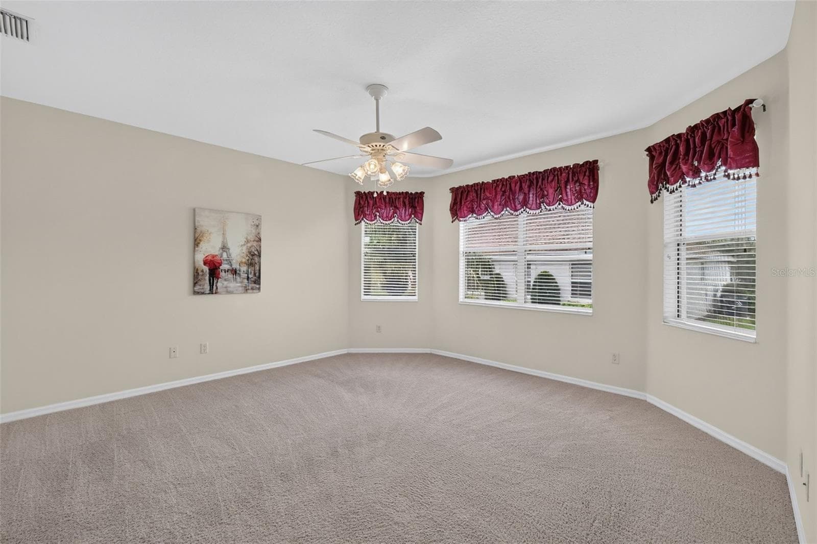 The spacious primary suite provides a relaxing retreat with dual walk-in closets - 2693 IRIS WAY, THE VILLAGES