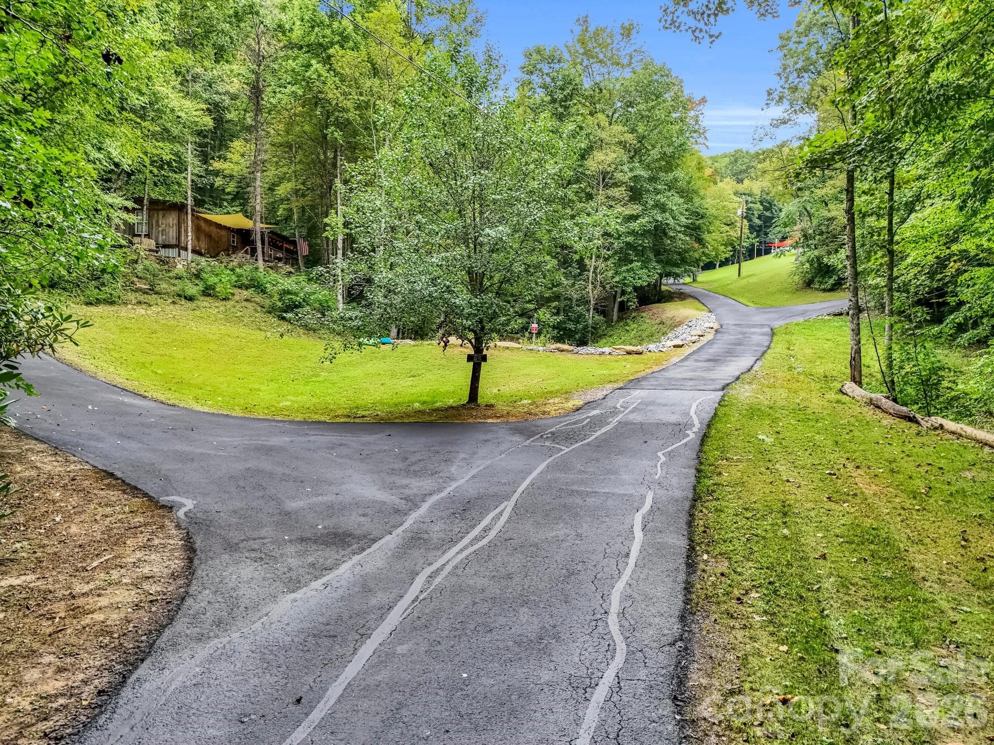 Drive leading to guest houses on left and main house on the hill - 97 Whippoorwill Lane, Fairview