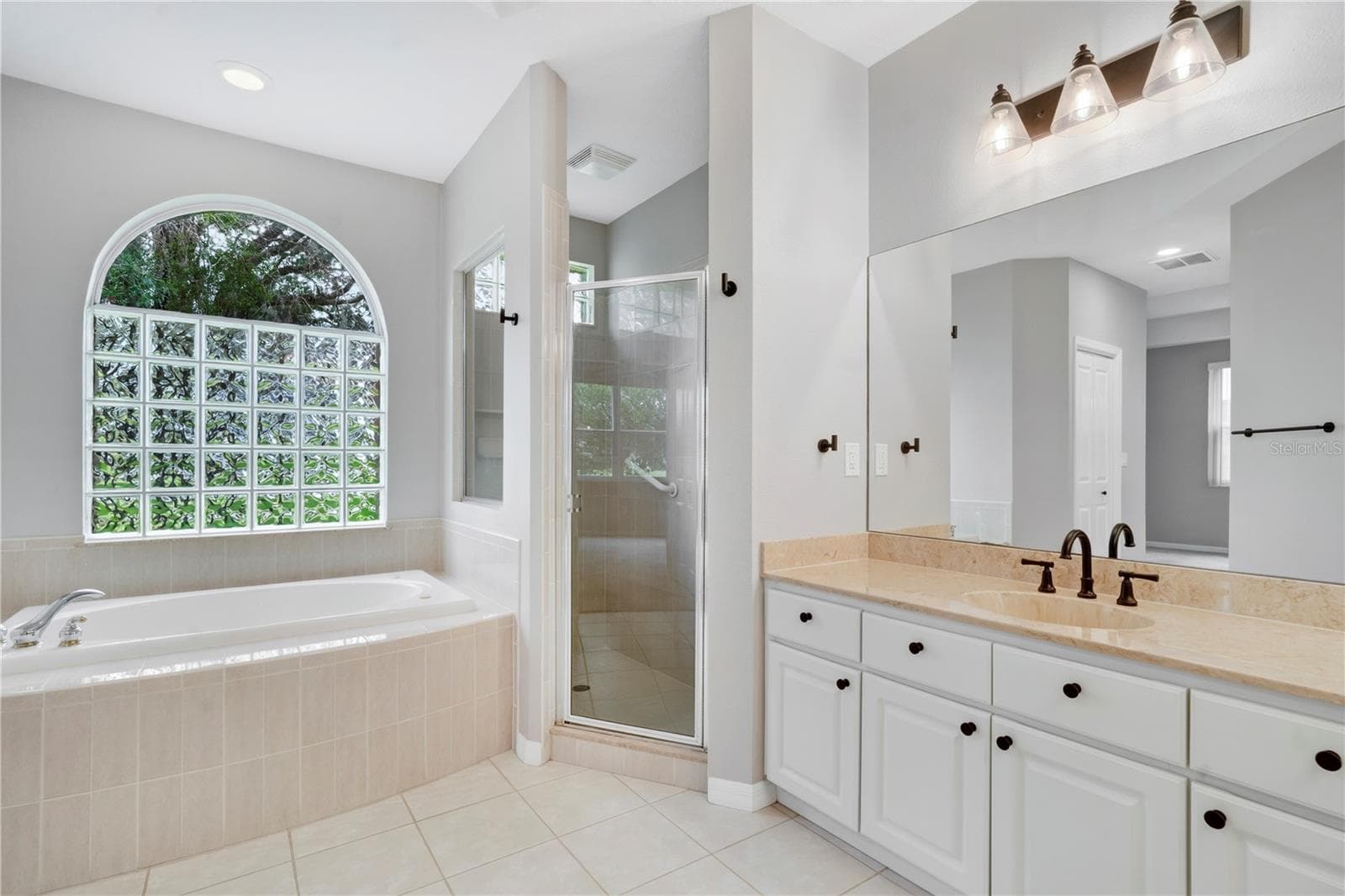PRIMARY BATHROOM/ DUAL SINKS / NEW FIXTURES TILE FLOOR/ SEPARATE LOU (TOILET) W/DOOR AREA - 9257 BONNIE COVE DR, WEEKI WACHEE