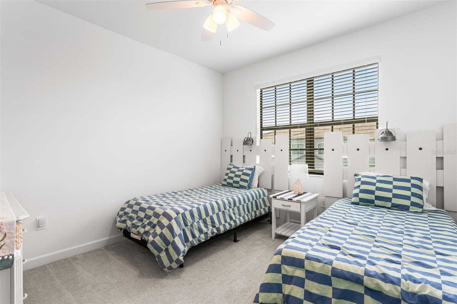 Two generous guest bedrooms at the front of the home are thoughtfully decorated with beach-themed accents, creating a welcoming coastal vibe - 14275 PINE LODGE LN, FORT MYERS