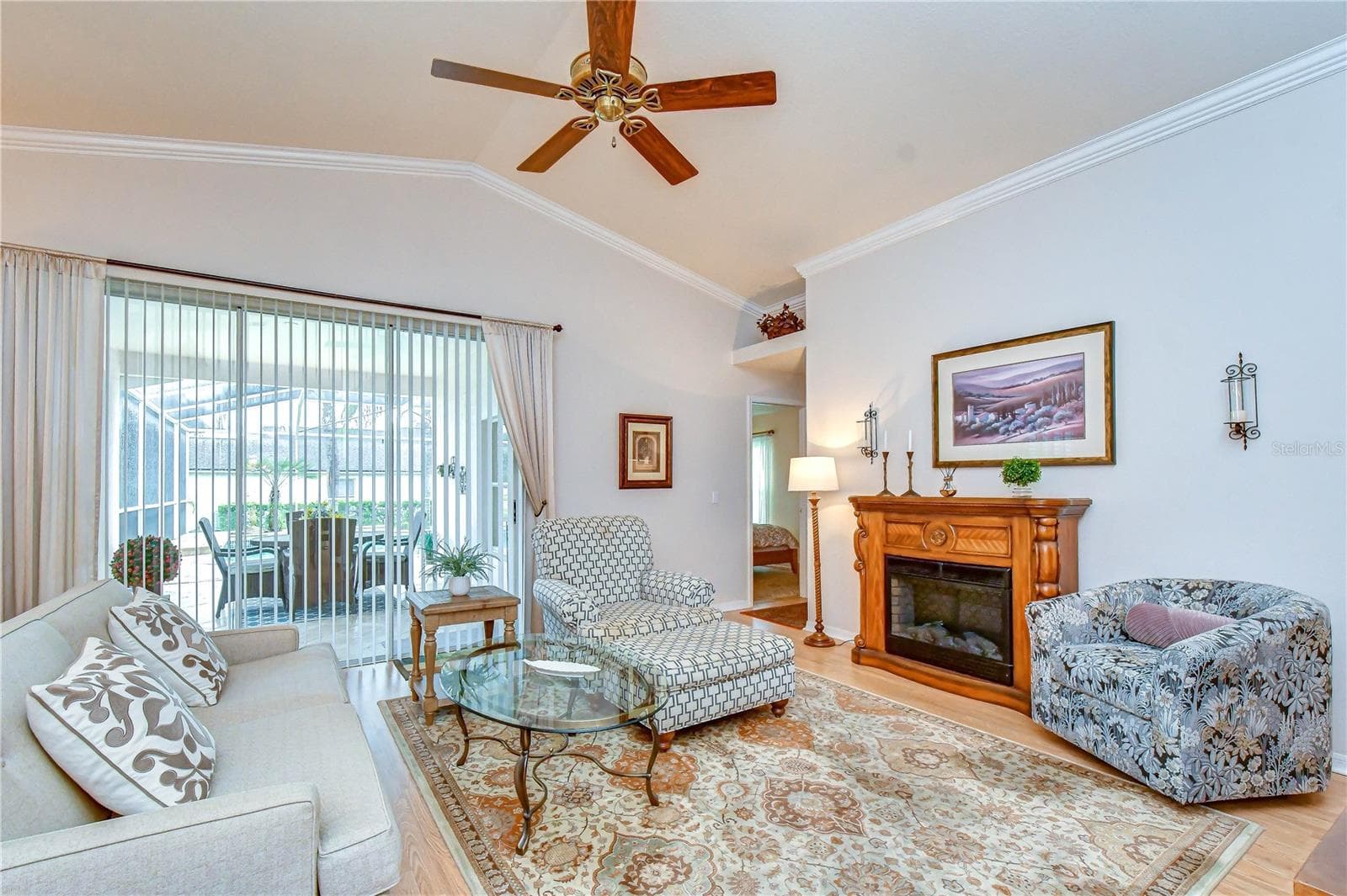 Spacious gathering area featuring soaring vaulted ceilings and sliding glass doors overlooking the pool and golf course. - 5602 ROCKFIELD LOOP, VALRICO