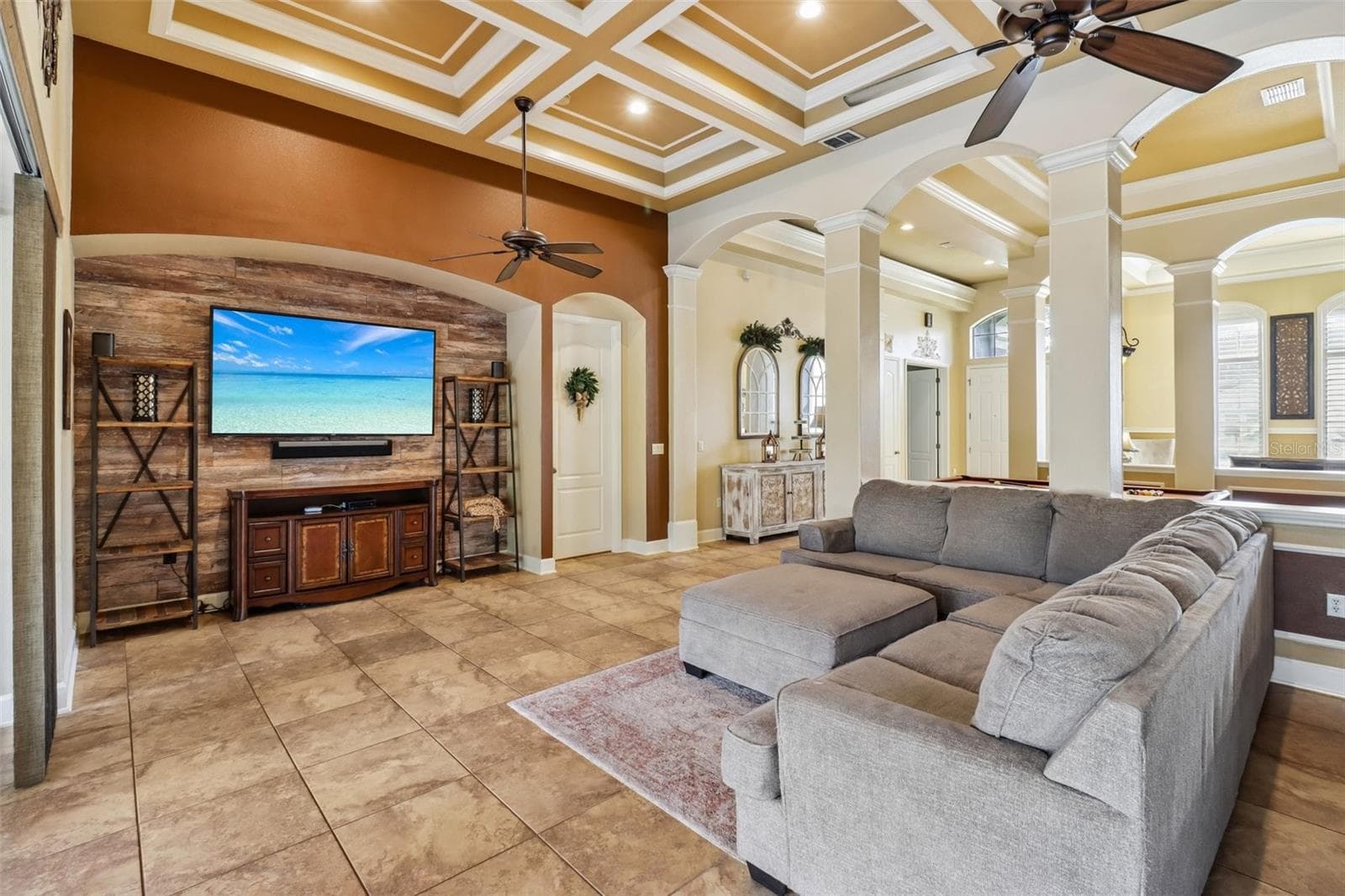 Family room is open to the kitchen with a wall of sliding glass doors that open to the lanai and pool. - 2947 CEDAR CREST DR, APOPKA