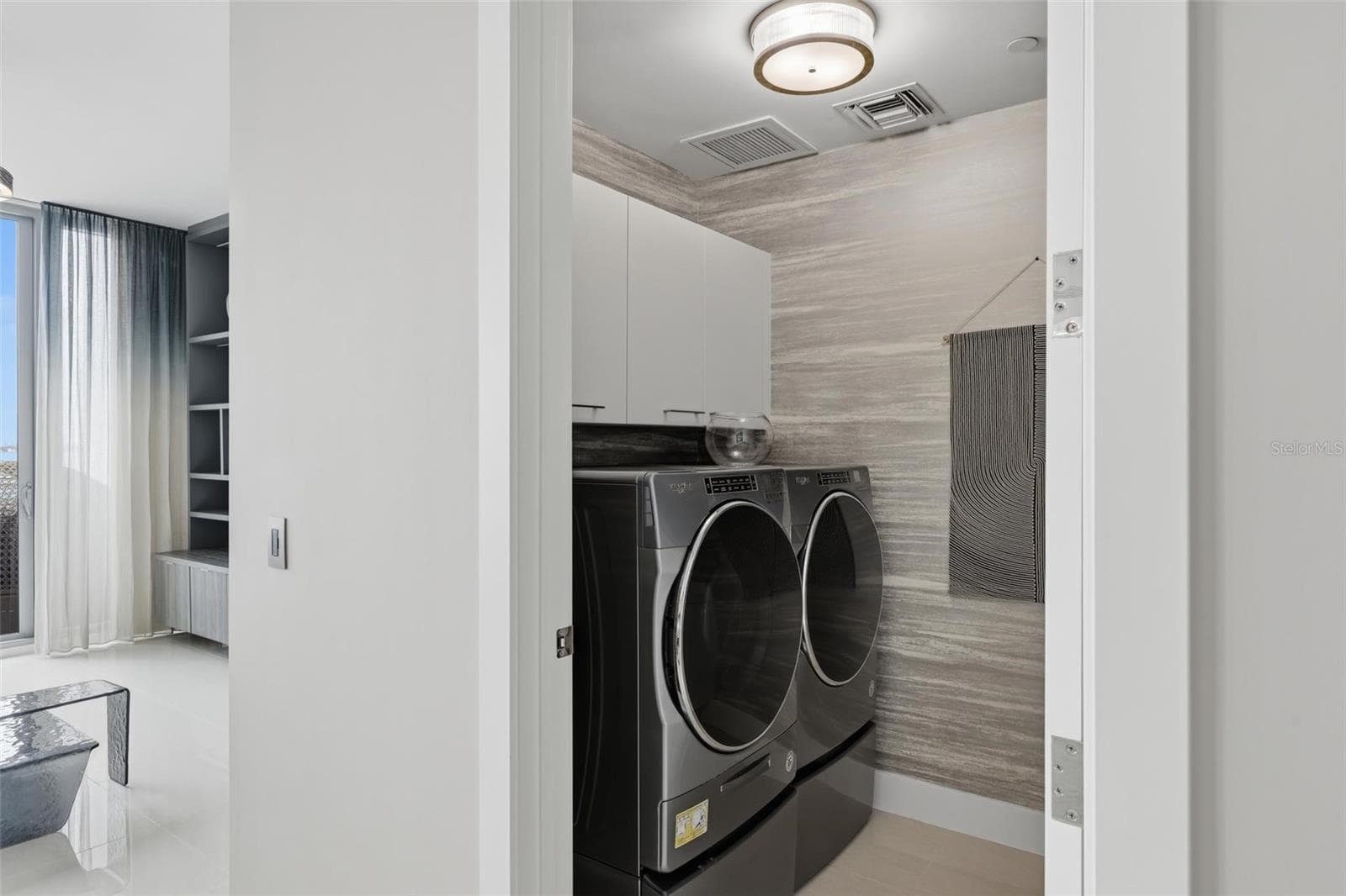 Practical storage cabinets in laundry room, across from kitchen. - 1155 N GULFSTREAM AVE #807, SARASOTA