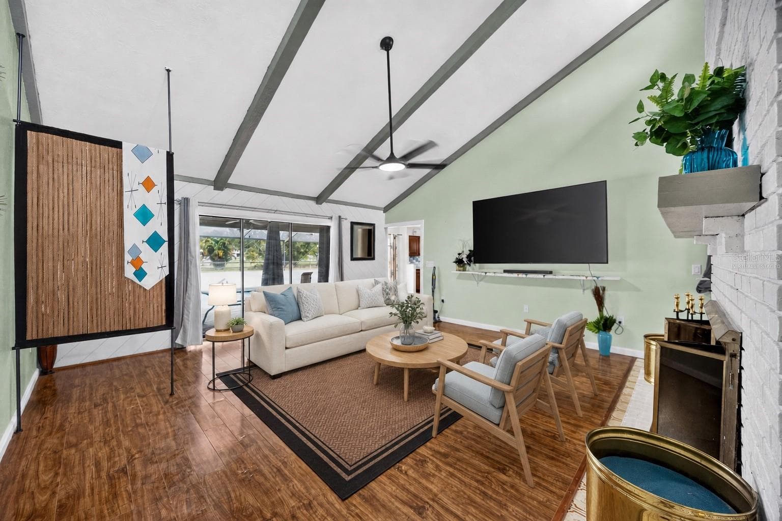 Virtually staged - Great room with fireplace, TV and pool access. - 1305 GREENFIELD CIR, VENICE