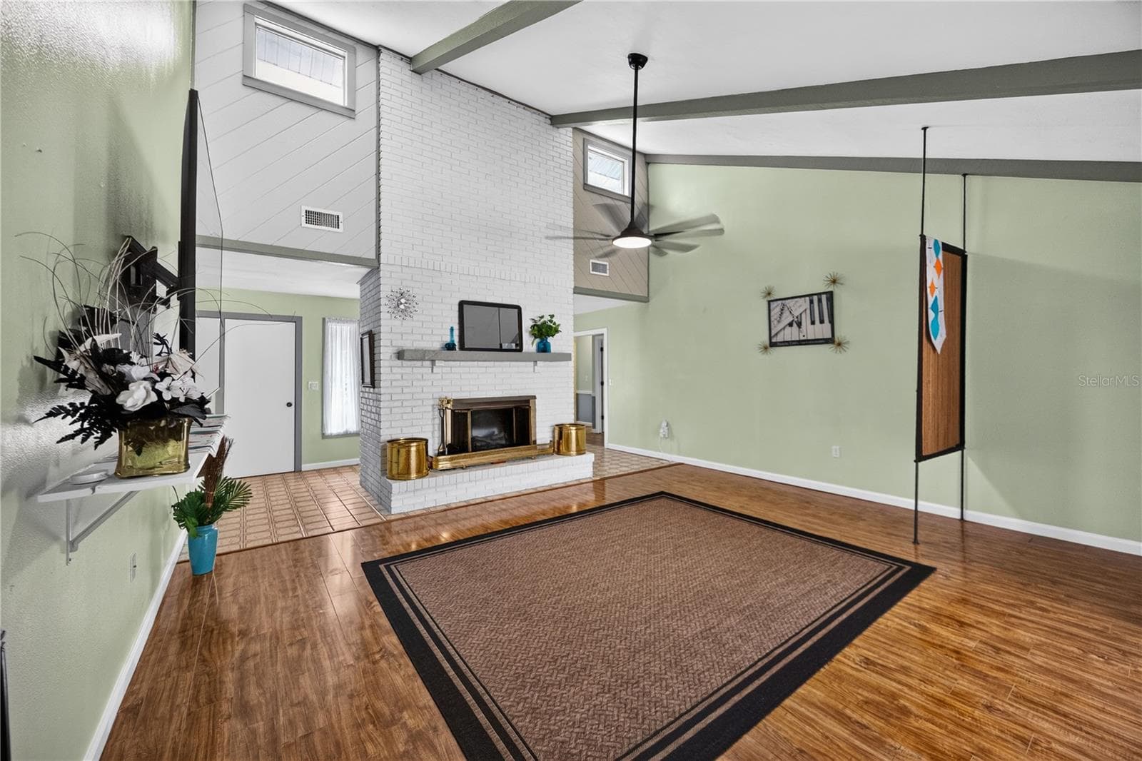 Great room with vaulted ceiling, fireplace and pool access. - 1305 GREENFIELD CIR, VENICE