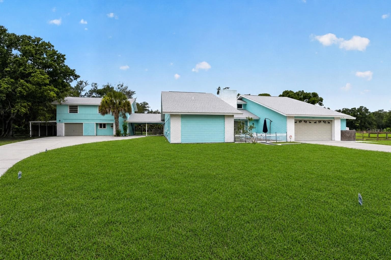 Front elevation across the expansive lawn. - 1305 GREENFIELD CIR, VENICE