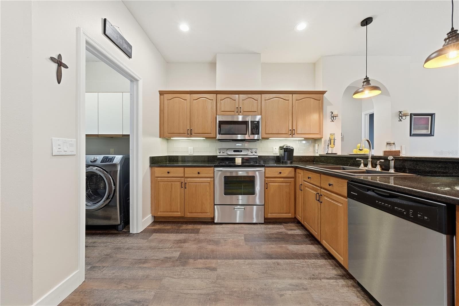 Functional kitchen with abundant cabinetry, generous counter space and easy flow into the adjoining living and dining areas. - 2360 PARK FOREST BLVD, MOUNT DORA