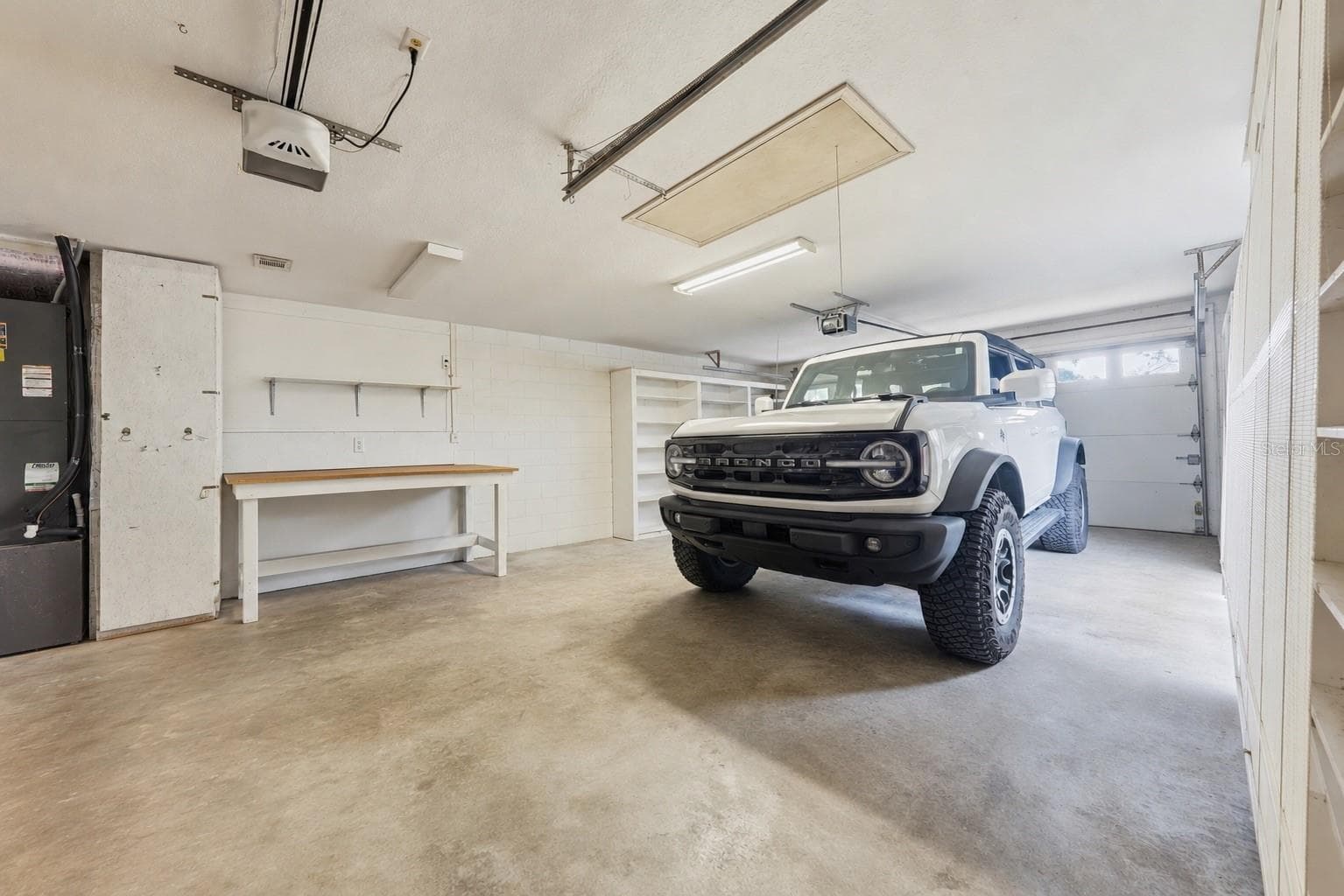 Oversized garage with a dedicated golf cart door. - 2360 PARK FOREST BLVD, MOUNT DORA