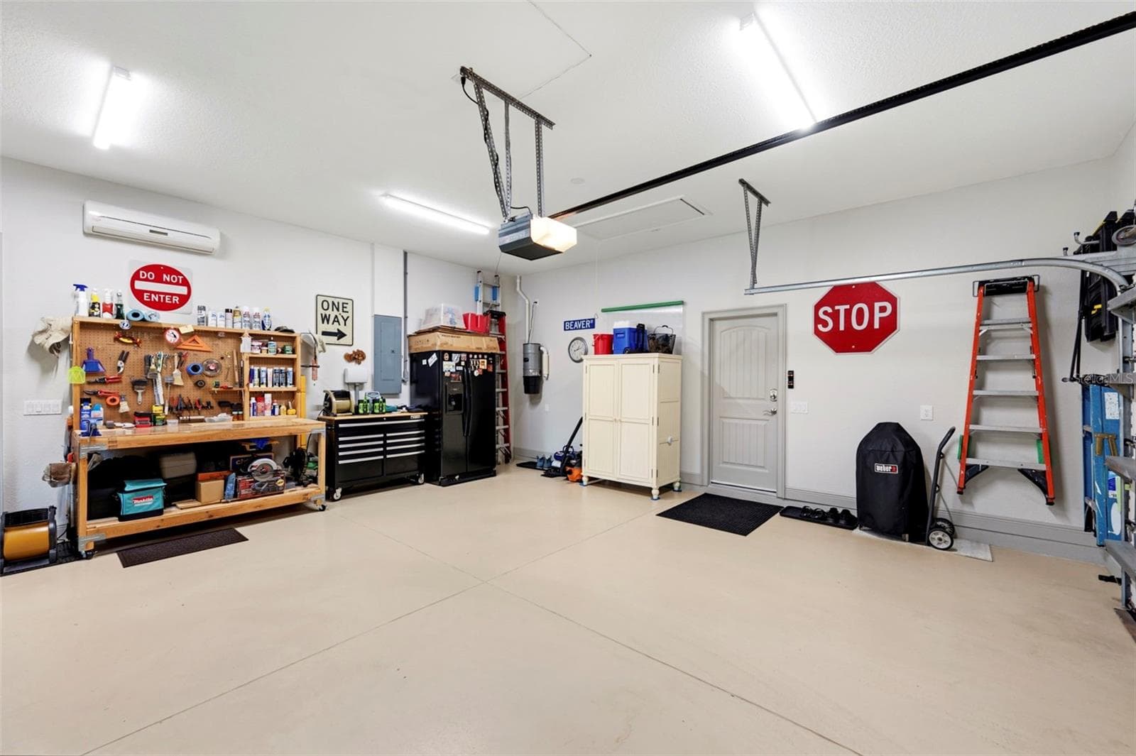 The garage fridge stays for the convenience of the new owner also note the central vac next to it - 3850 CREEKSIDE PARK DR, PARRISH