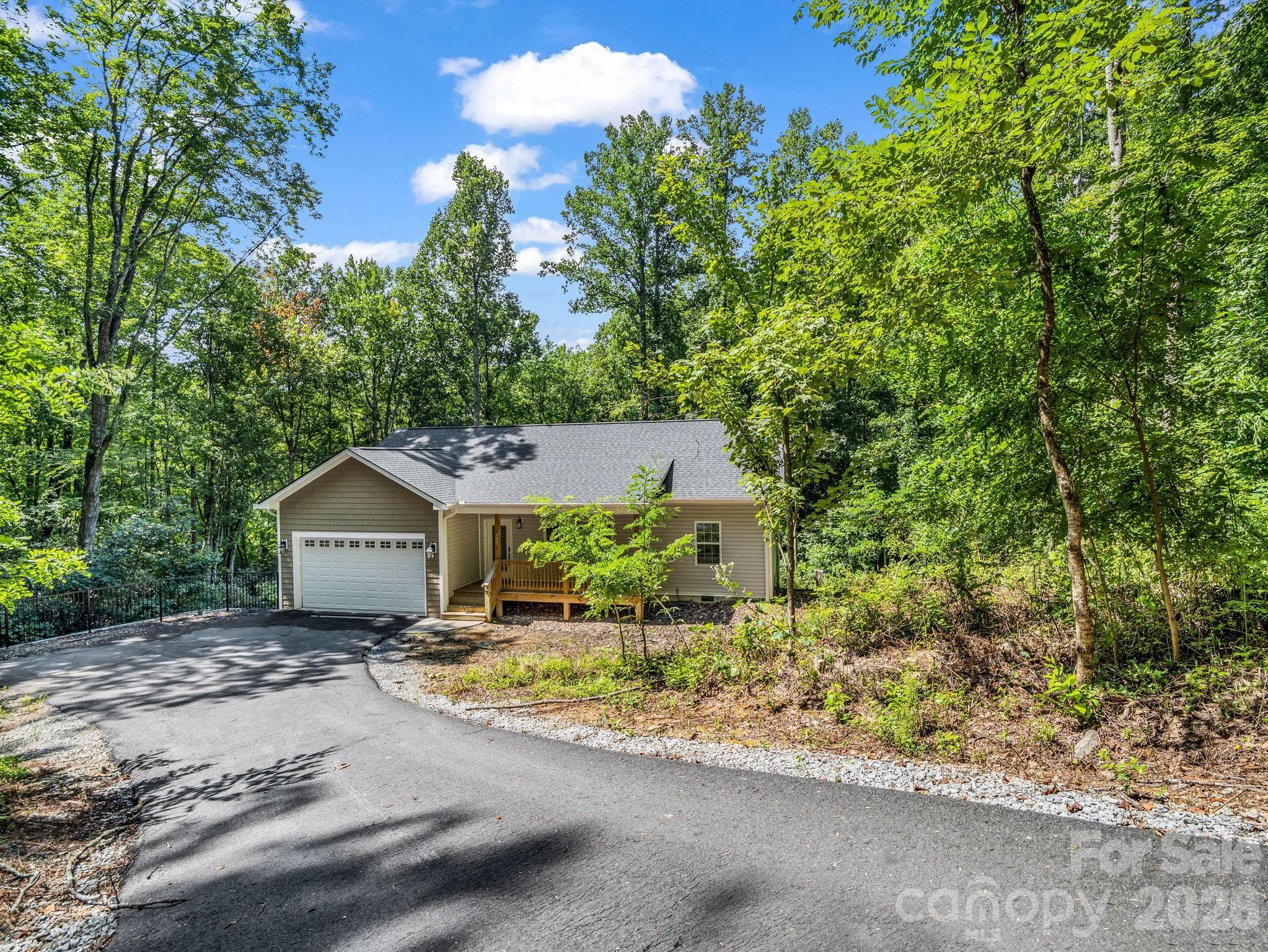 Welcome to 180 Ridgeview Drive. View from the top of the driveway off Ridgeview Drive down to the house. - 180 Ridgeview Drive, Hendersonville