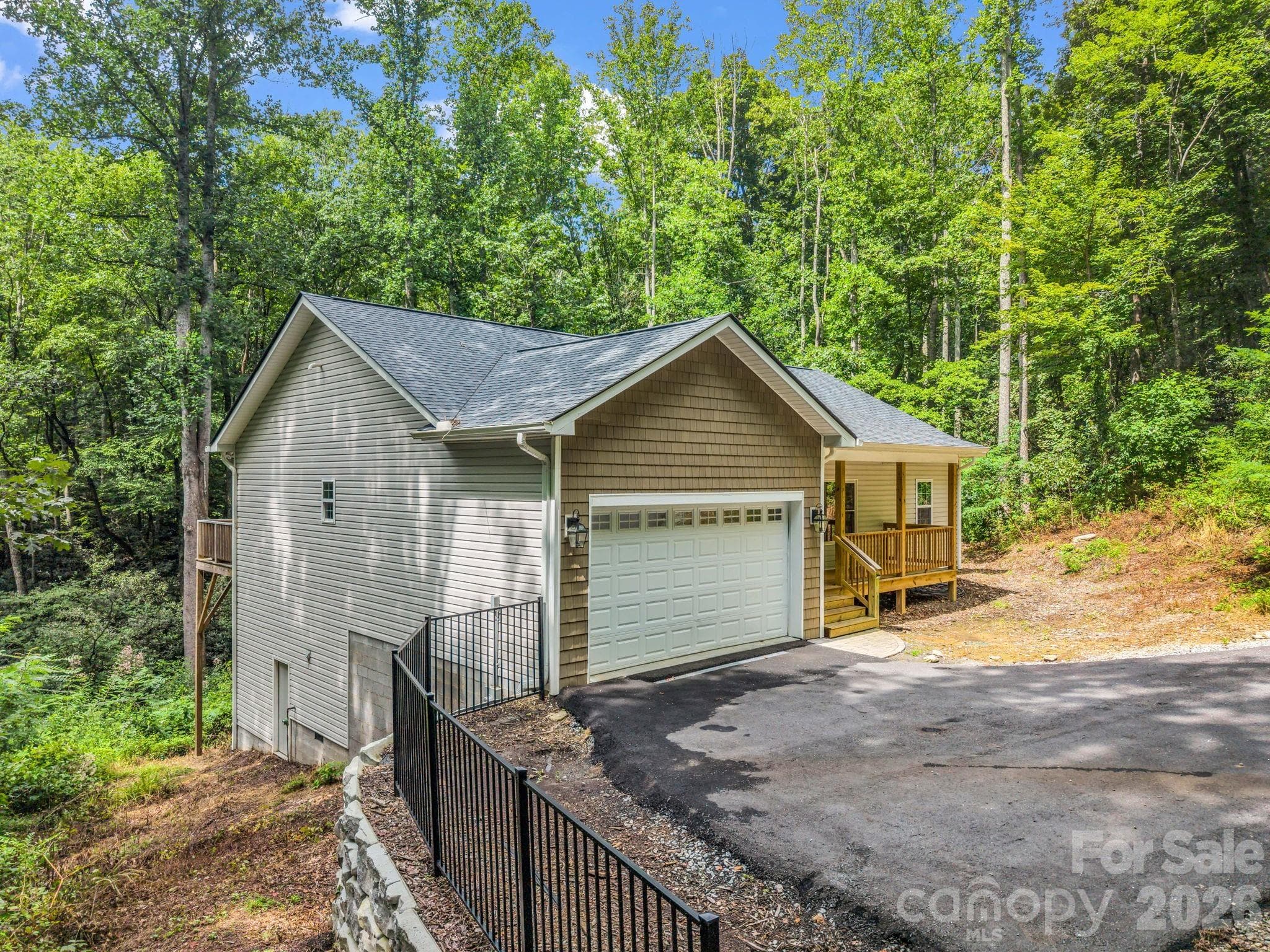 Left side of the house, the door on the lower left is the crawlspace entrance. - 180 Ridgeview Drive, Hendersonville