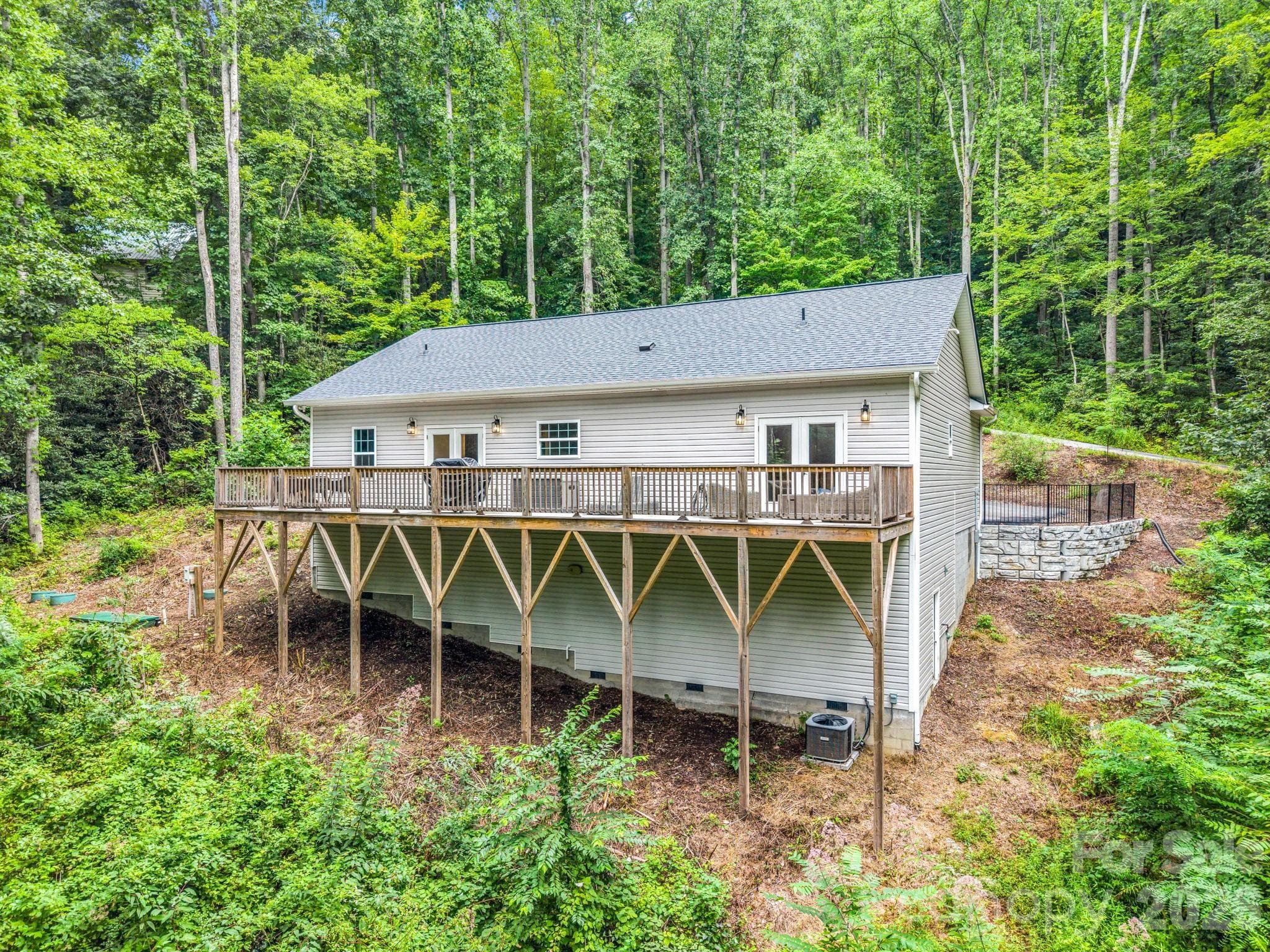 The huge back deck runs the whole length of the house. - 180 Ridgeview Drive, Hendersonville