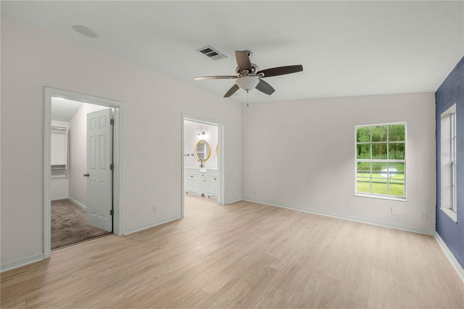 Primary entry door view of closet door and primary bathroom - 13250 NW 160TH AVE, MORRISTON