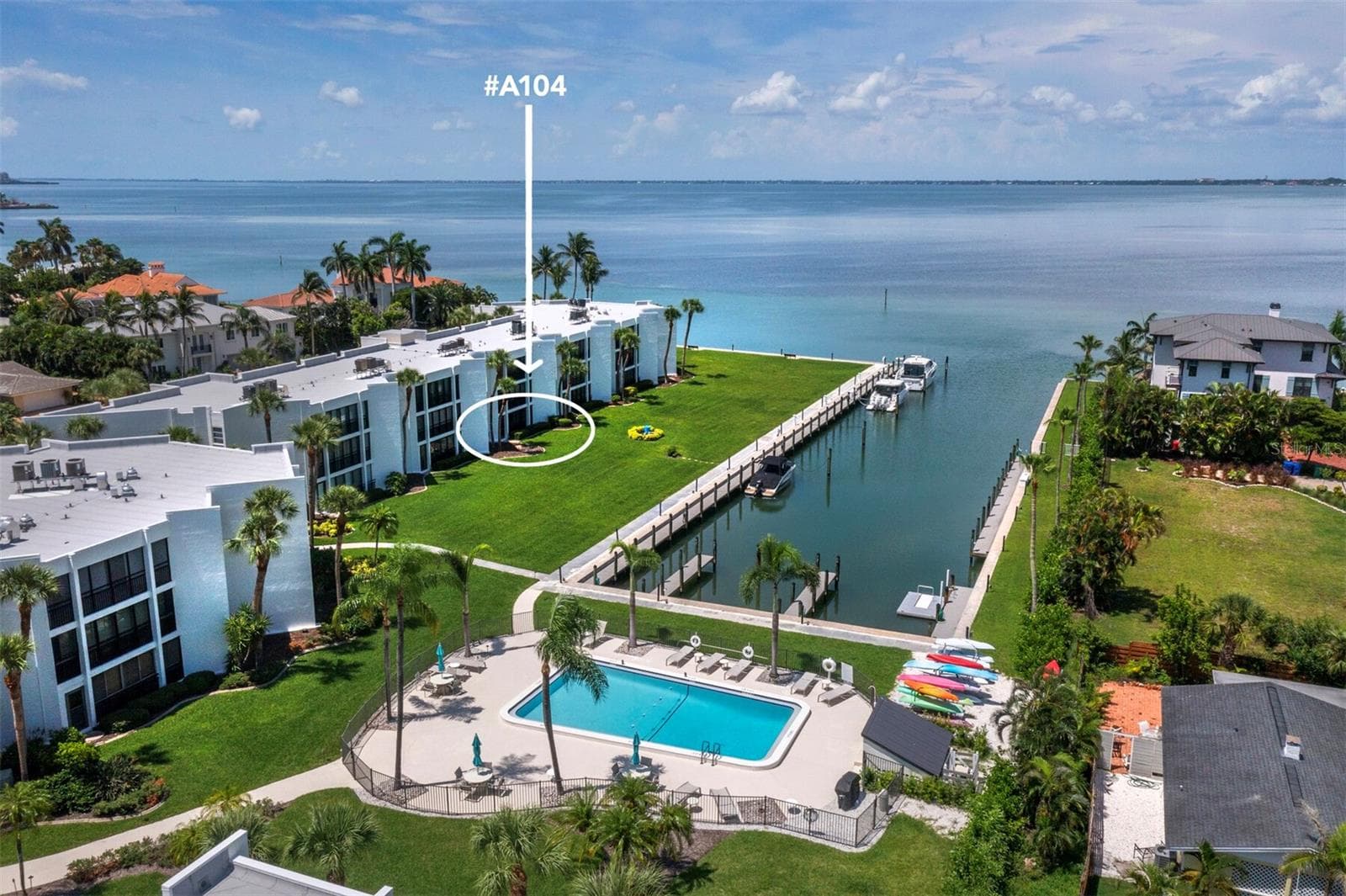 Eastern perspective of A104, pool, marina and Sarasota Bay - 448 GULF OF MEXICO DR #A104, LONGBOAT KEY