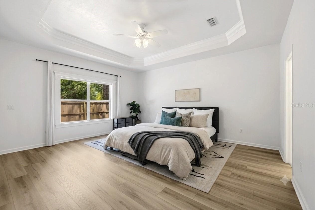 Primary Bedroom on first floor - virtual bedding - 3033 SW 98TH DR, GAINESVILLE