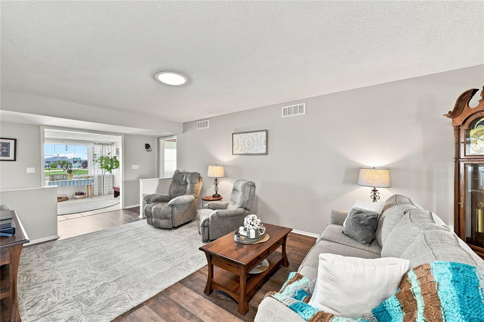 Living/Dining Combo, Large Entry Picture Window, Freshly Painted Interior, Beautiful Laminate Oak Plank Flooring - 1405 HACIENDA DR, SUN CITY CENTER