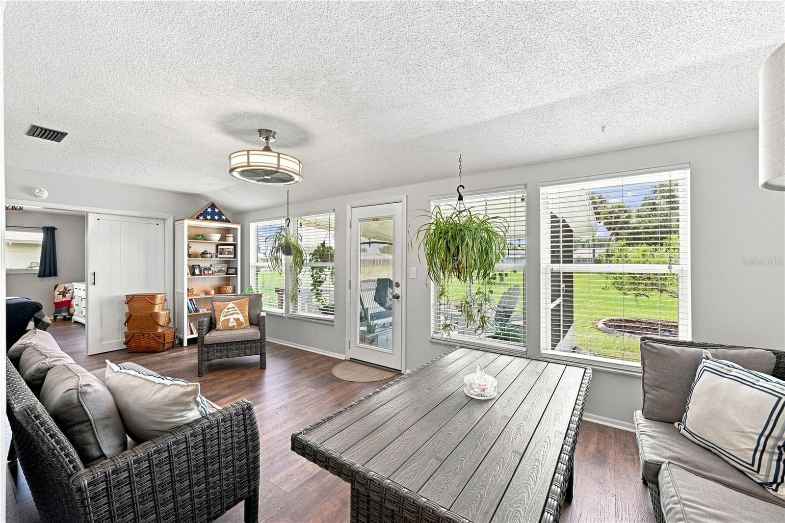 Bright & Sunny Enclosed Lanai/Florida Room, Beautiful Laminate Oak Plank Flooring, Newer Windows - 1405 HACIENDA DR, SUN CITY CENTER