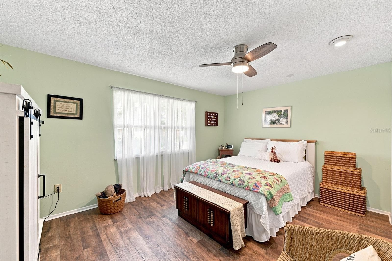 Spacious & Inviting Front Guest Room, Beautiful Laminate Oak Plank Flooring, Additional Closet Space, New Modern Fan - 1405 HACIENDA DR, SUN CITY CENTER