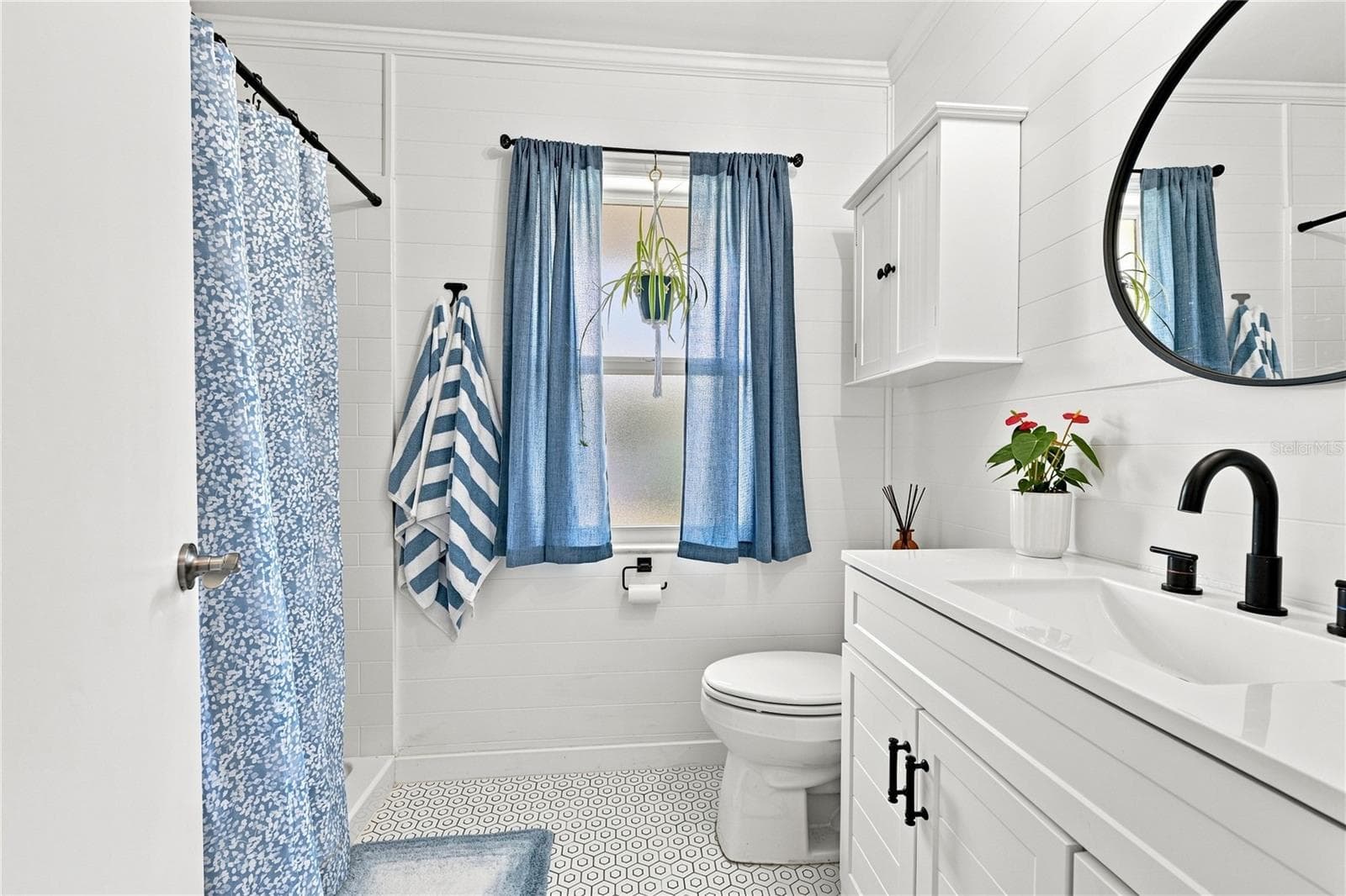 Remodeled Coastal Flair PrimaryEn-Suite Bath, Wainscoting, High Top Vanity & Walk-In Shower - 1405 HACIENDA DR, SUN CITY CENTER