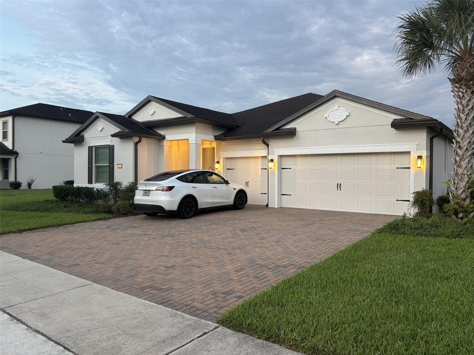 14048 Larkspur Lake Dr - Front exterior view featuring the three-car garage and expansive driveway can fit 6 vehicles in the driveway. - 14048 LARKSPUR LAKE DR, WINTER GARDEN