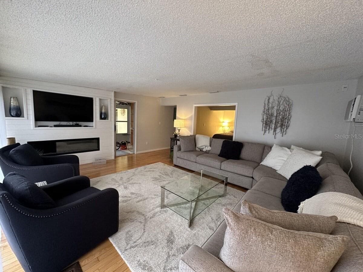 Electric fireplace and TV in a comfortable atmosphere. - 5955 MIDNIGHT PASS RD #21E, SARASOTA