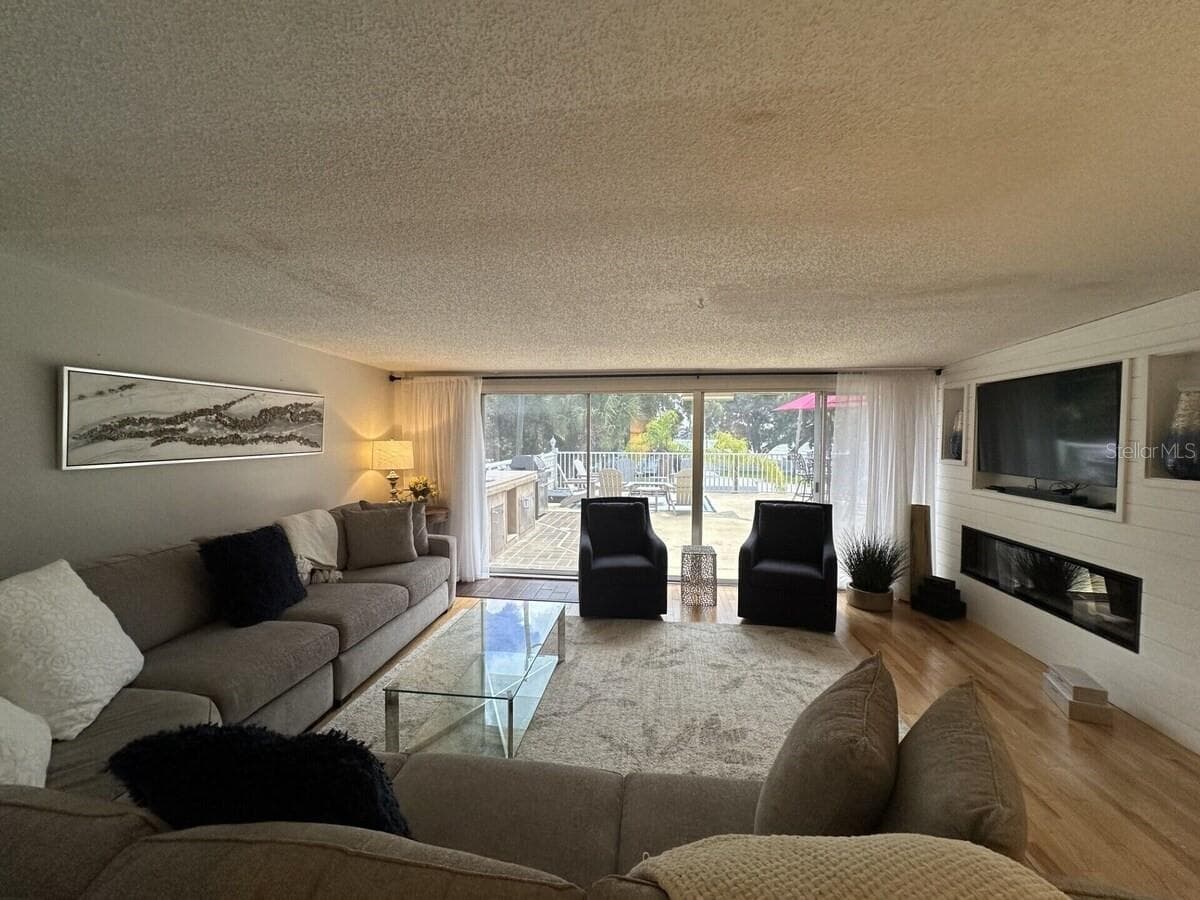 Living area with patio doors to large patio area. - 5955 MIDNIGHT PASS RD #21E, SARASOTA