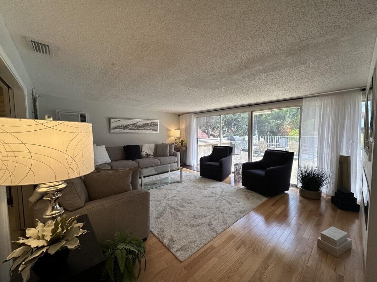 Another living area picture with access to patio. - 5955 MIDNIGHT PASS RD #21E, SARASOTA