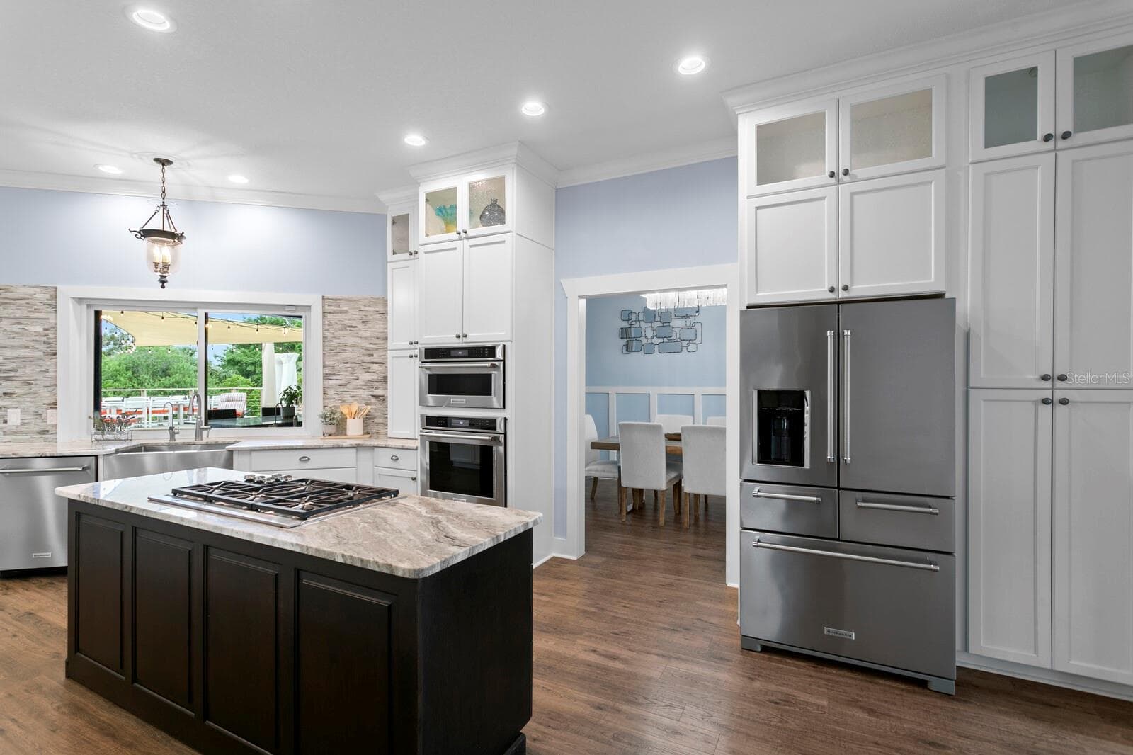 Wolf 5 burner cooktop with JennAir retractable vent. Kitchenaid 5-door refrigerator and built-in convection oven and microwave - 704 EAGLE LN, APOLLO BEACH