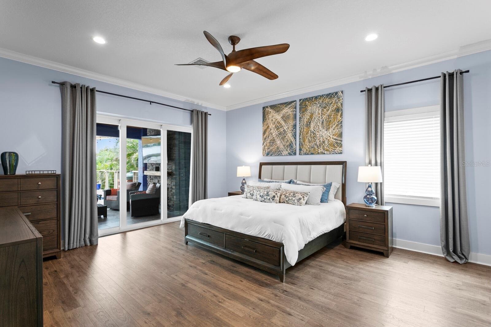 Primary bedroom with triple pocket sliding impact door leading to covered patio - 704 EAGLE LN, APOLLO BEACH