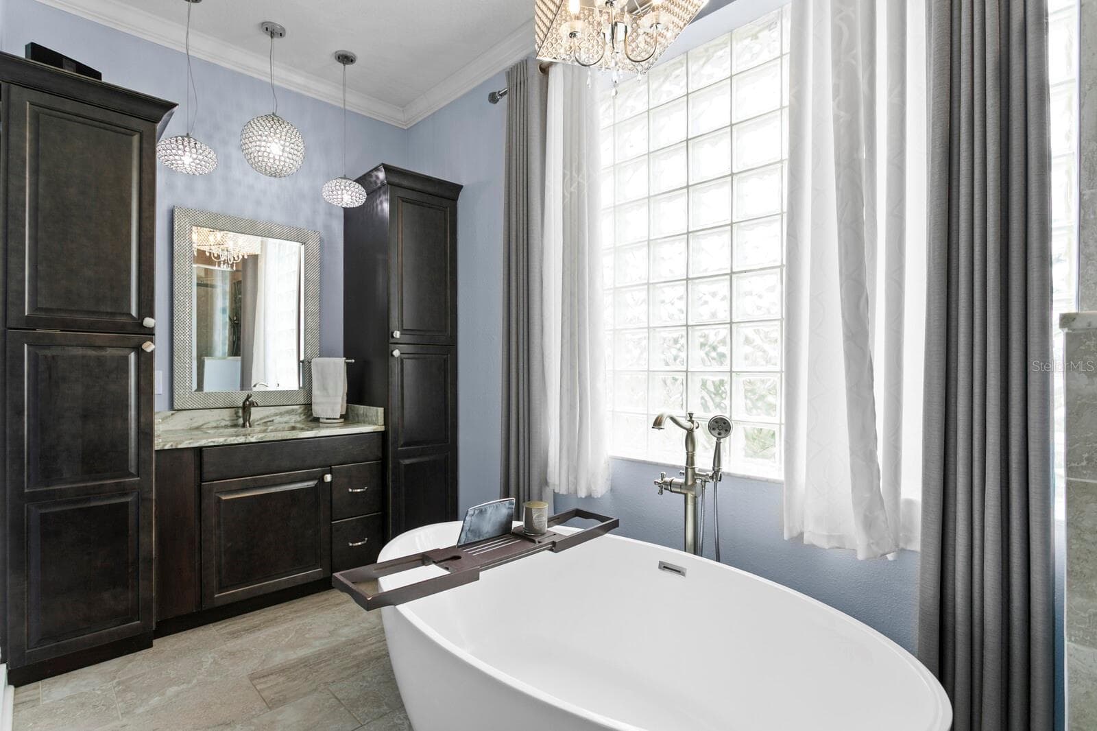 Ensuite bath features custom lighting, spit vanities, and glass-block window - 704 EAGLE LN, APOLLO BEACH